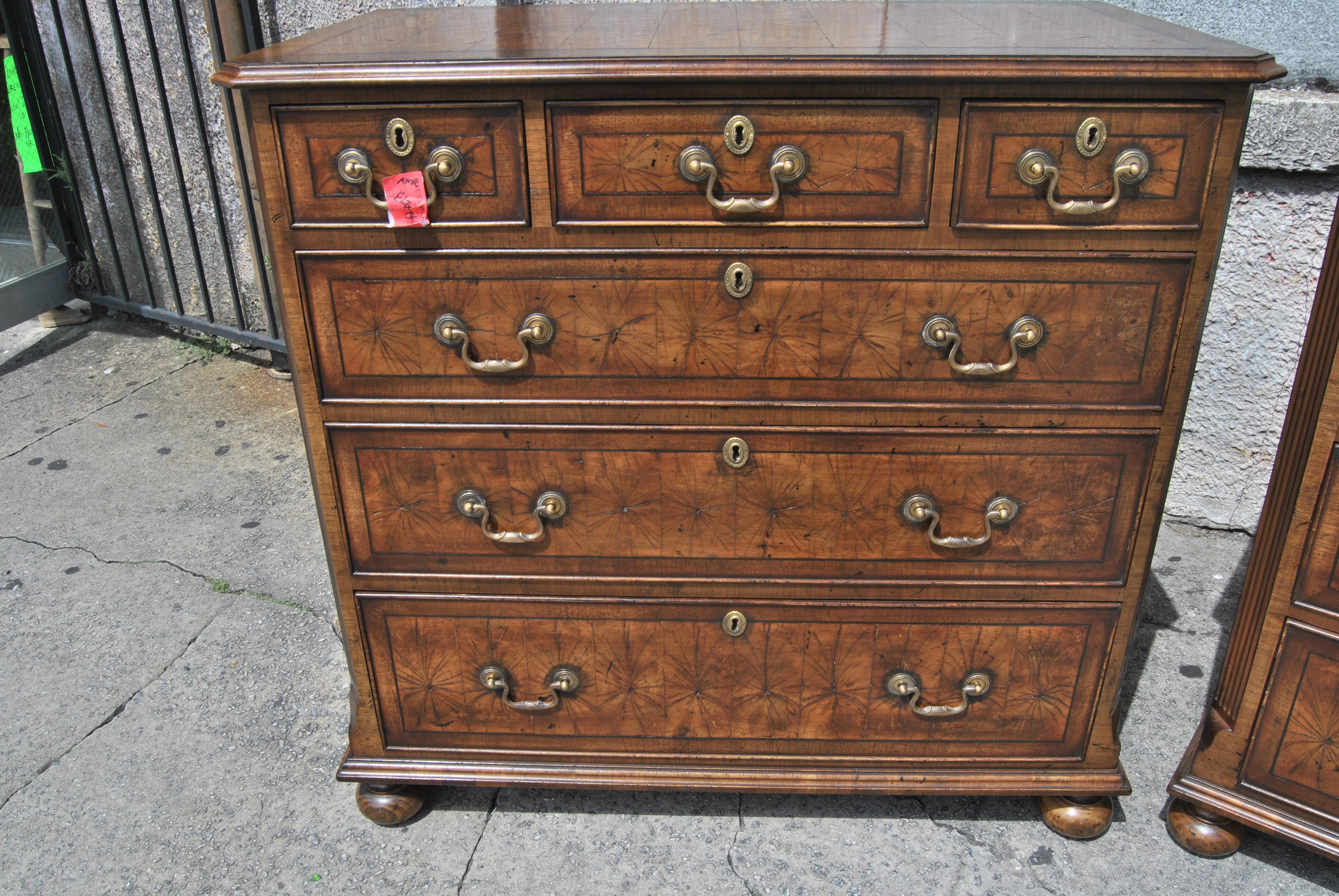 This is a pair of chest of drawers, done in an oyster cut of walnut, made in England, circa 1800. The top of each chest has a nicely molded edge. The tops and all drawer fronts are banded in Walnut with a string inlay of ebony and beautiful, highly