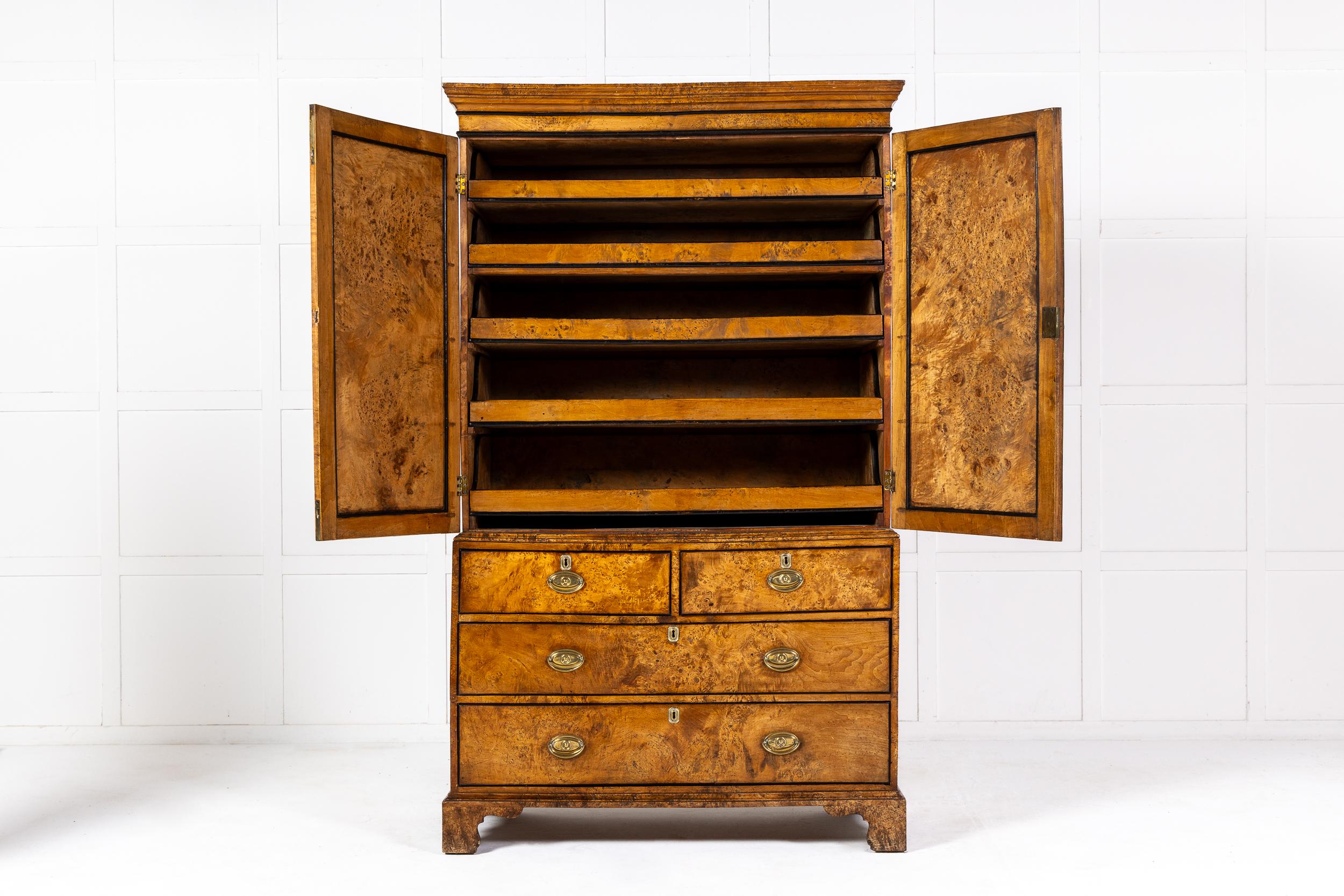 A Late 18th or Early 19th Century Linen Press Cupboard Constructed from Solid Sycamore and of Exceptional Colour.

The linen press of typical form with two panelled doors concealing five slides for clothes and linen in the upper section and an