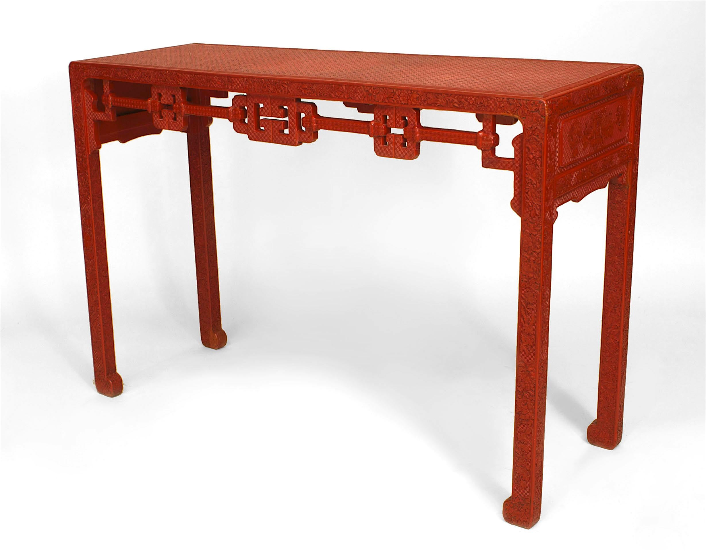 Asian Chinese (18/19th Century) red cinnabar console table with a carved floral design on legs and apron with a geometric design filigree apron and top. (Christie's Richard Himmel Collection)
