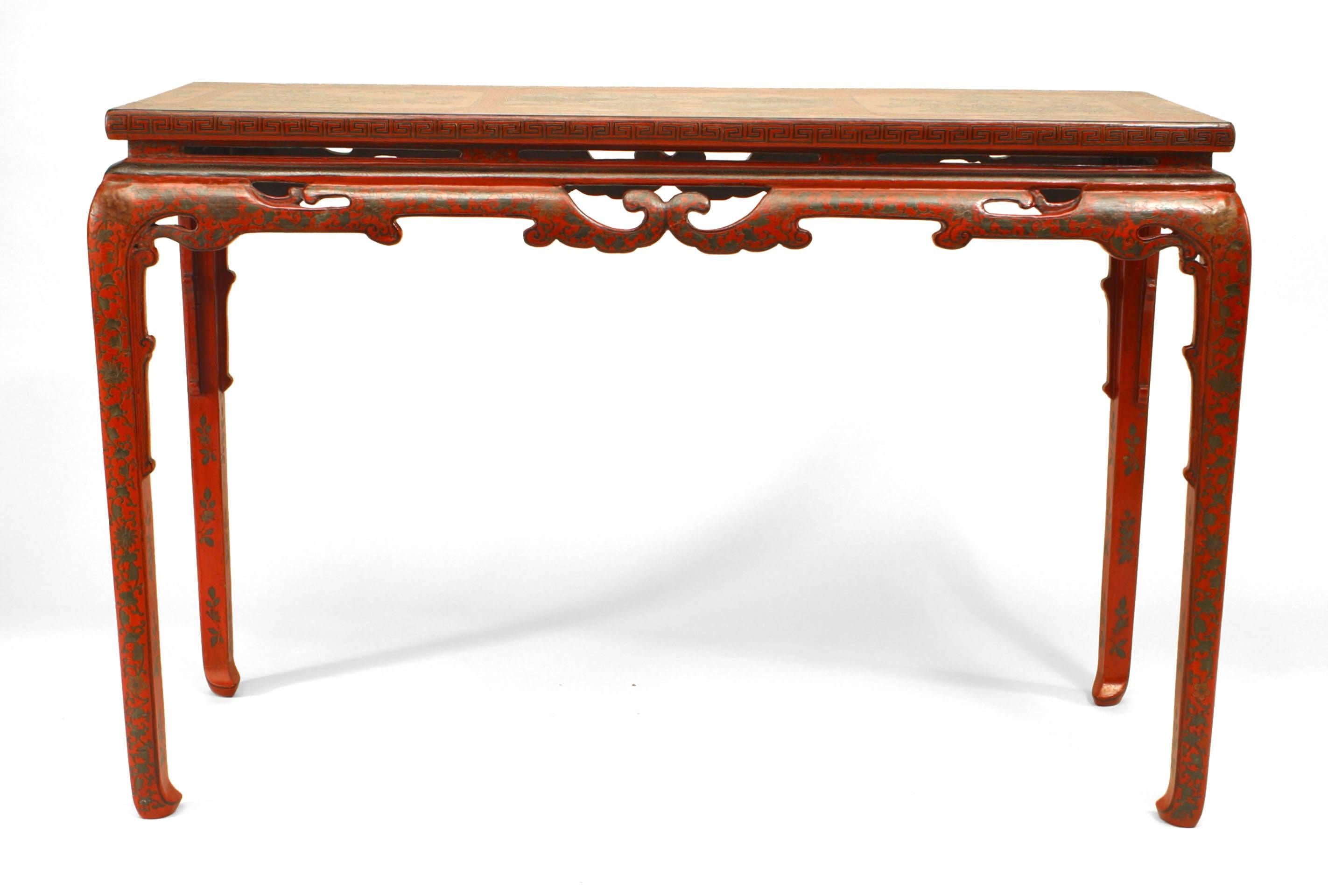 Chinese console table dating to the eighteenth or nineteenth century. The table features a red lacquer surface decorated with floral and bird motifs as well as floral design legs and a cut-out design apron.