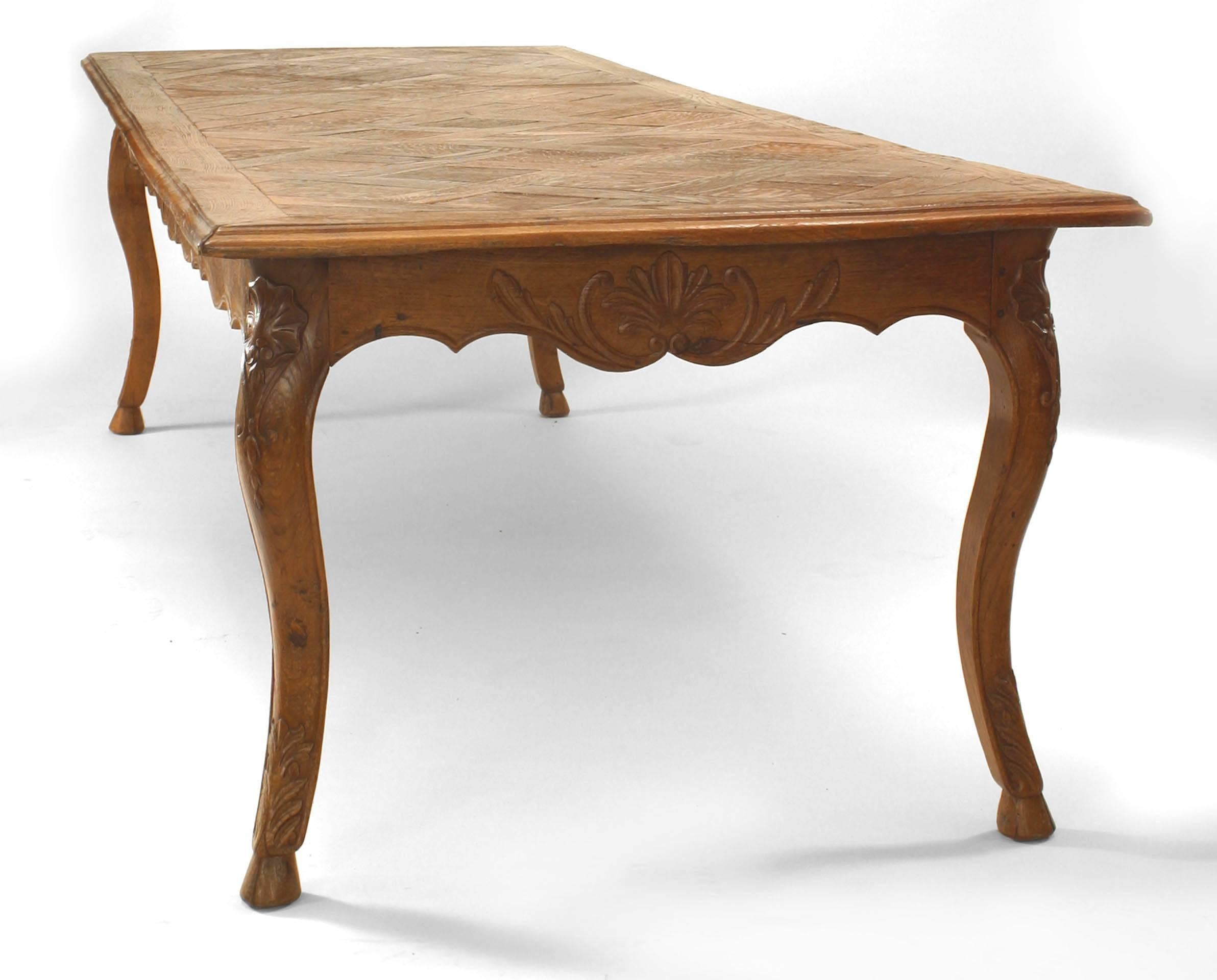 French Provincial-style (18/19th Century) oak dining table with parquetry top and carved apron
