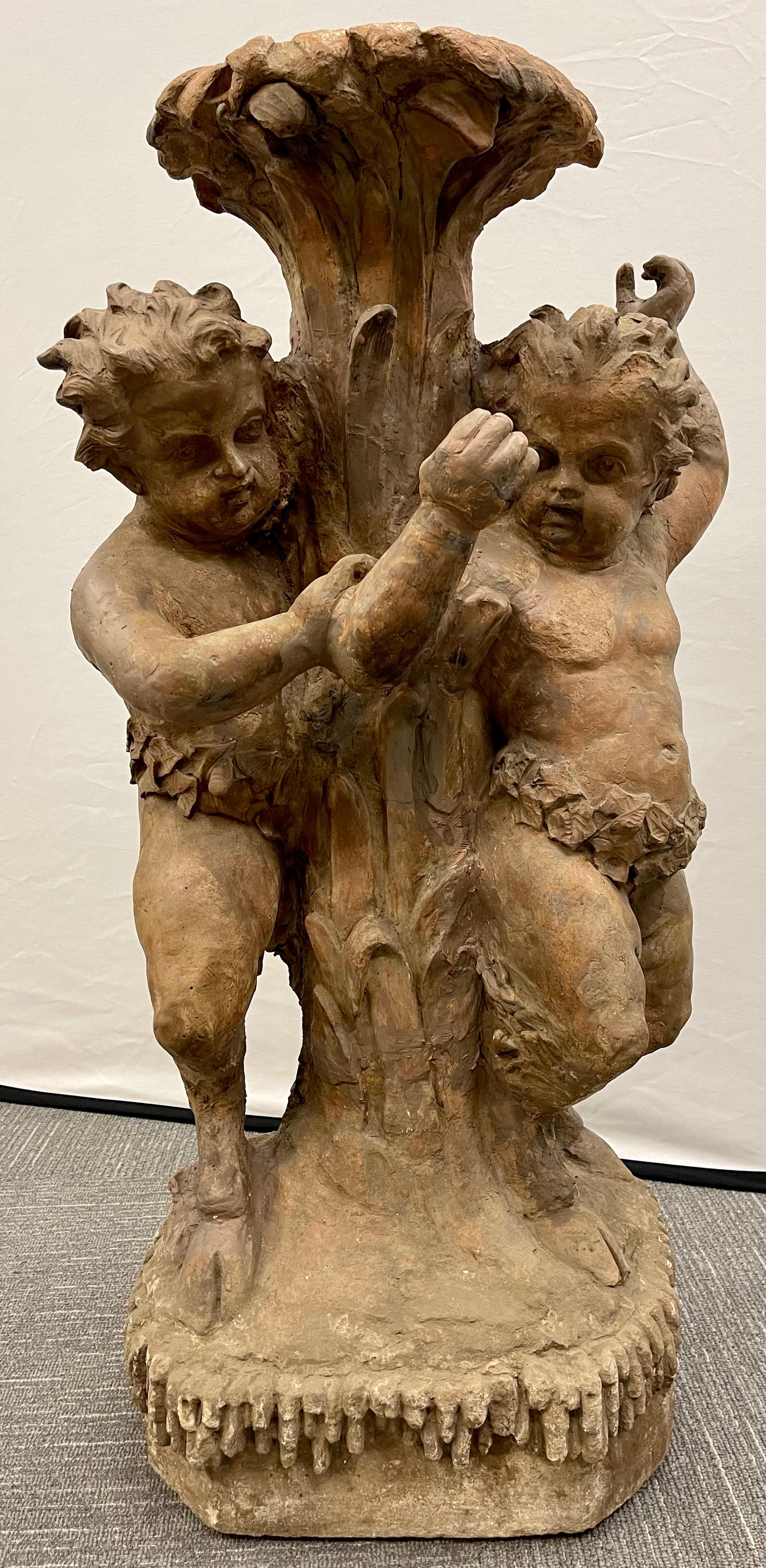 Late 18 or early 19th century Italian terracotta putti figural fountain / planter base. This spectacular base would make any bird bath or floral centerpiece look magnificent. The large and impressive full figured putti holding up a missing pot.
 