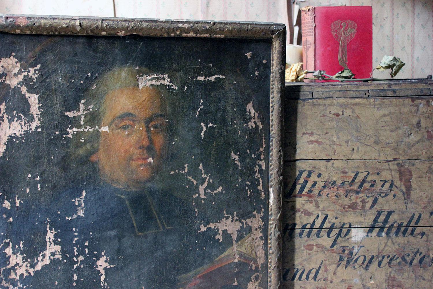 The beautifully worn half-length portrait in rectangular form of a Normandy priest, painted in oils on canvas and in its original beaded gesso frame, the sitter wearing a priests cassock and holding a book of prayer looking out amicably to the