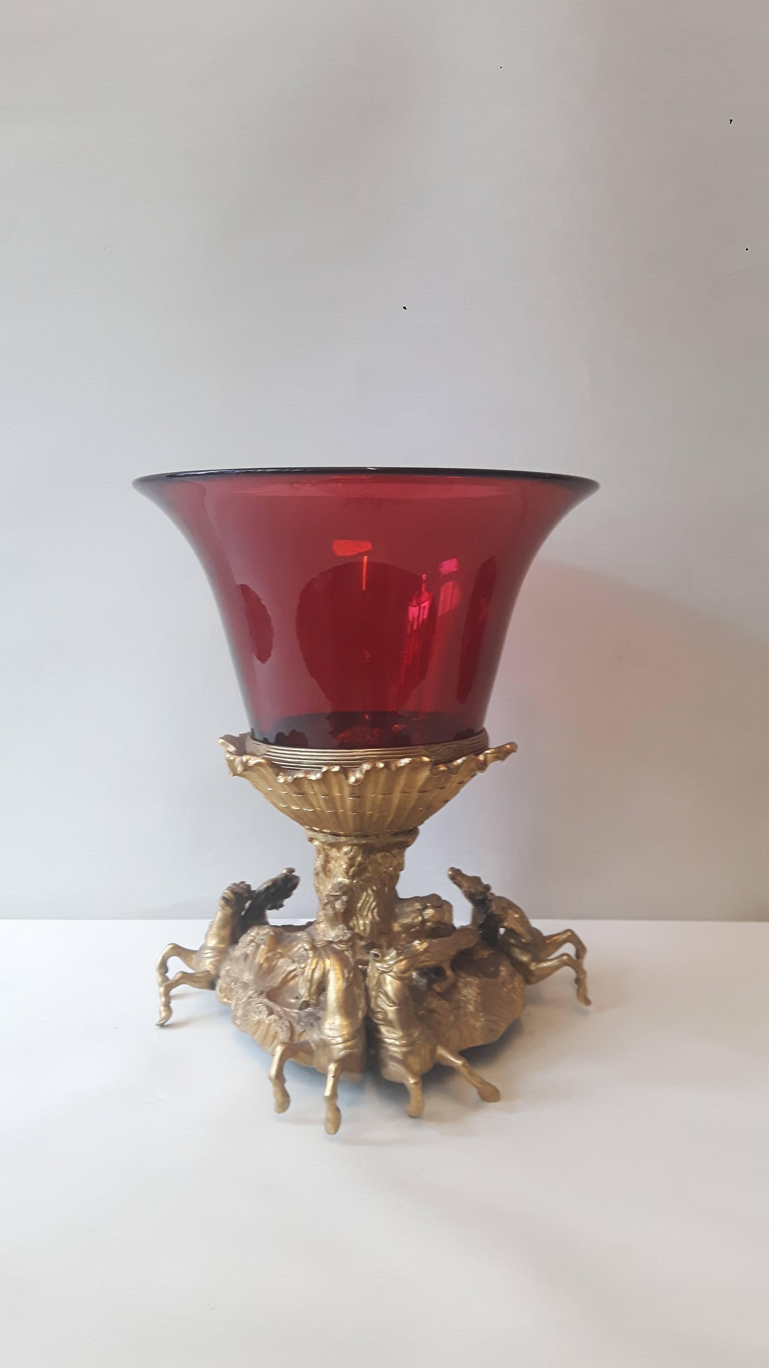 A wonderful ruby red glass and ormolu gilt centrepiece, the bottom part modelled on the fountain at the old Chateau de Marly, of four bronze horses rising up through the waves. 
 
 