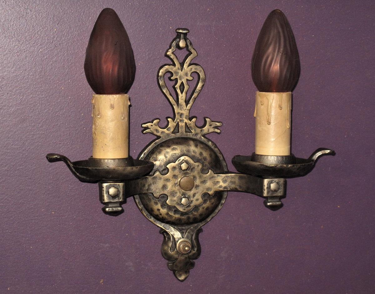 Vintage 1930s cast iron wall sconces, made by Virden. Captivating design with elements of Spanish Revival, Arts & Crafts, Tudor, and Craftsman all blended together very nicely. Needless to say these would fit right at home in any interior with the
