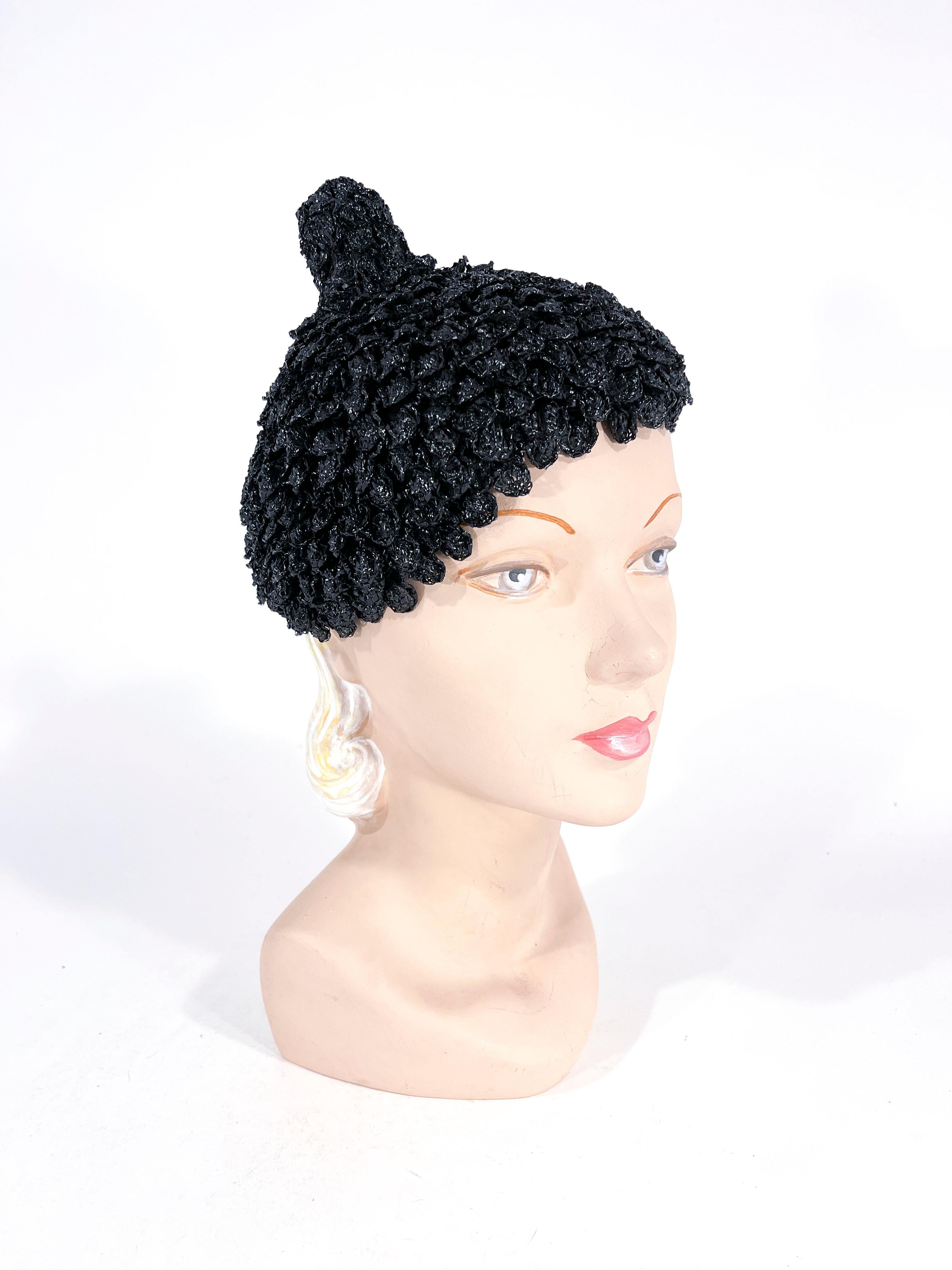 Late 1930s Hattie Carnegie black raffia hat woven in a multi-layered petal sprout silhouette. 