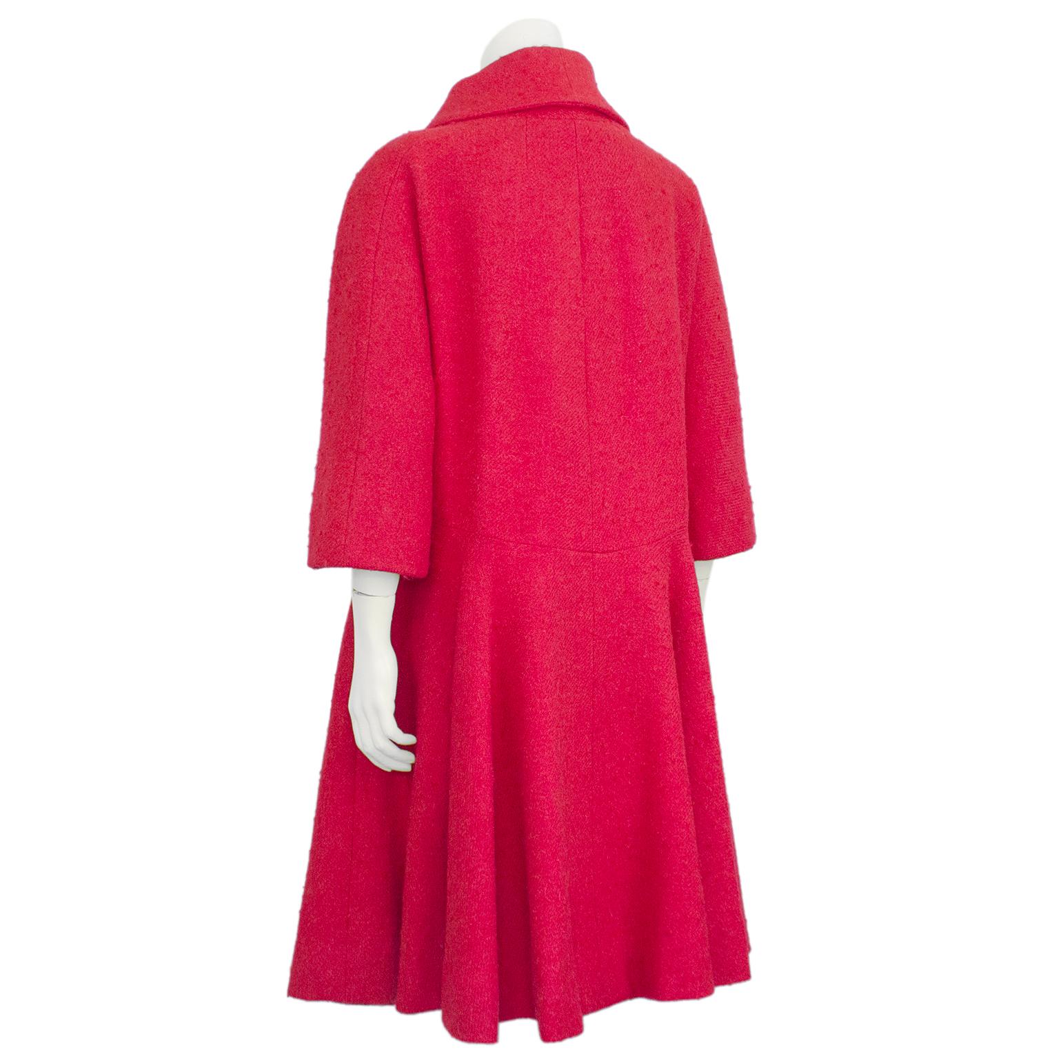 Shocking scarlet Pierre Cardin from the late 1960s. Incredible condition, the wool boucle exterior is cozy and bright with two front flap faux pockets. Double breasted closure with oversized matching scarlet buttons and bracelet/evening glove length