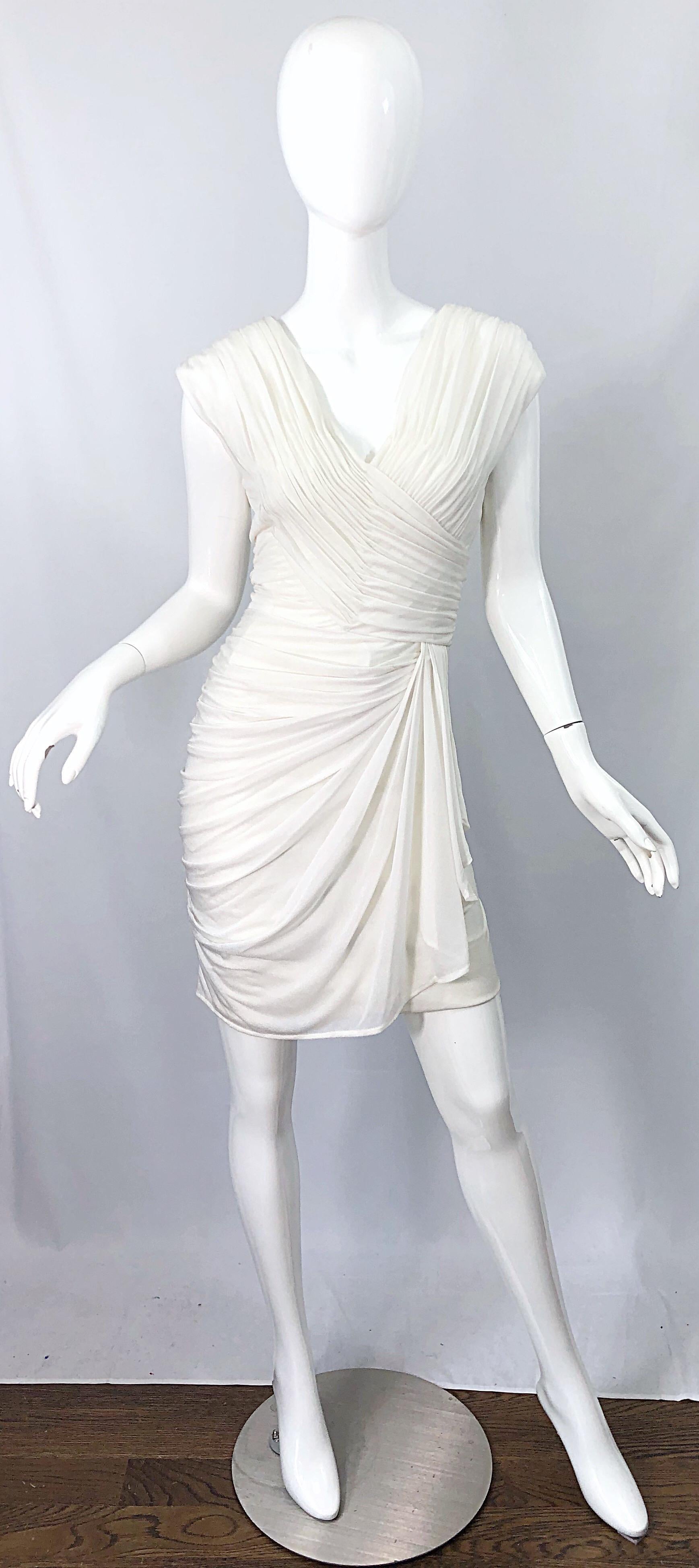 Beautiful Grecian inspired late 70s vintage LORIS AZZARO Couture white matte silk jersey mini dress ! Features flattering drapes and gathers that hide any flaws. Couture piece that is numbered. Full metal zipper up the back with hook-and-eye