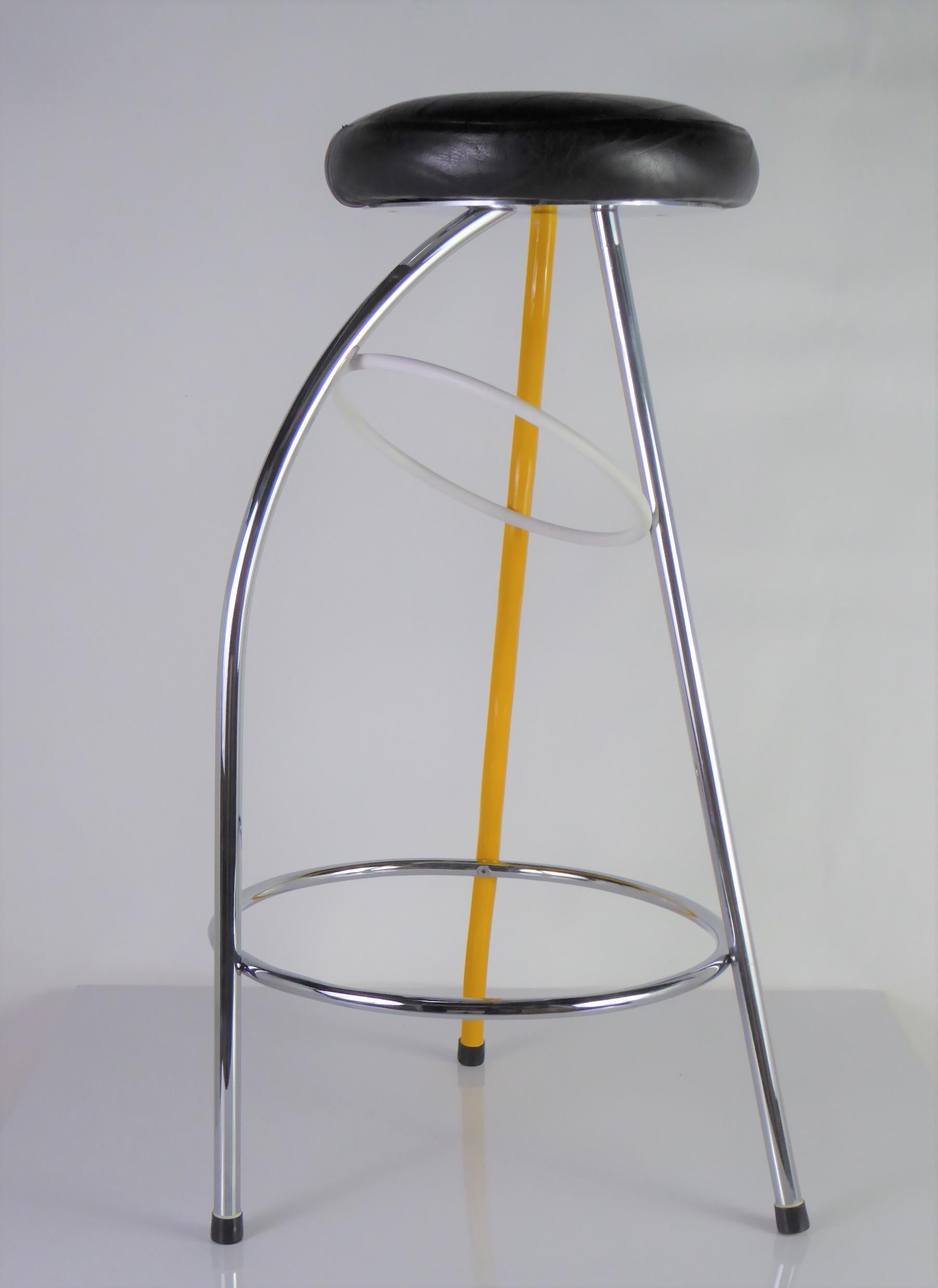 Designed for the Duplex Bar in Valencia, Spain in 1980 by Javier Mariscal. With a black leather seat, it rises on three legs, two in chrome and one undulating in yellow, with circular stretchers in chrome and white. Memphis fun. Sophisticated. In