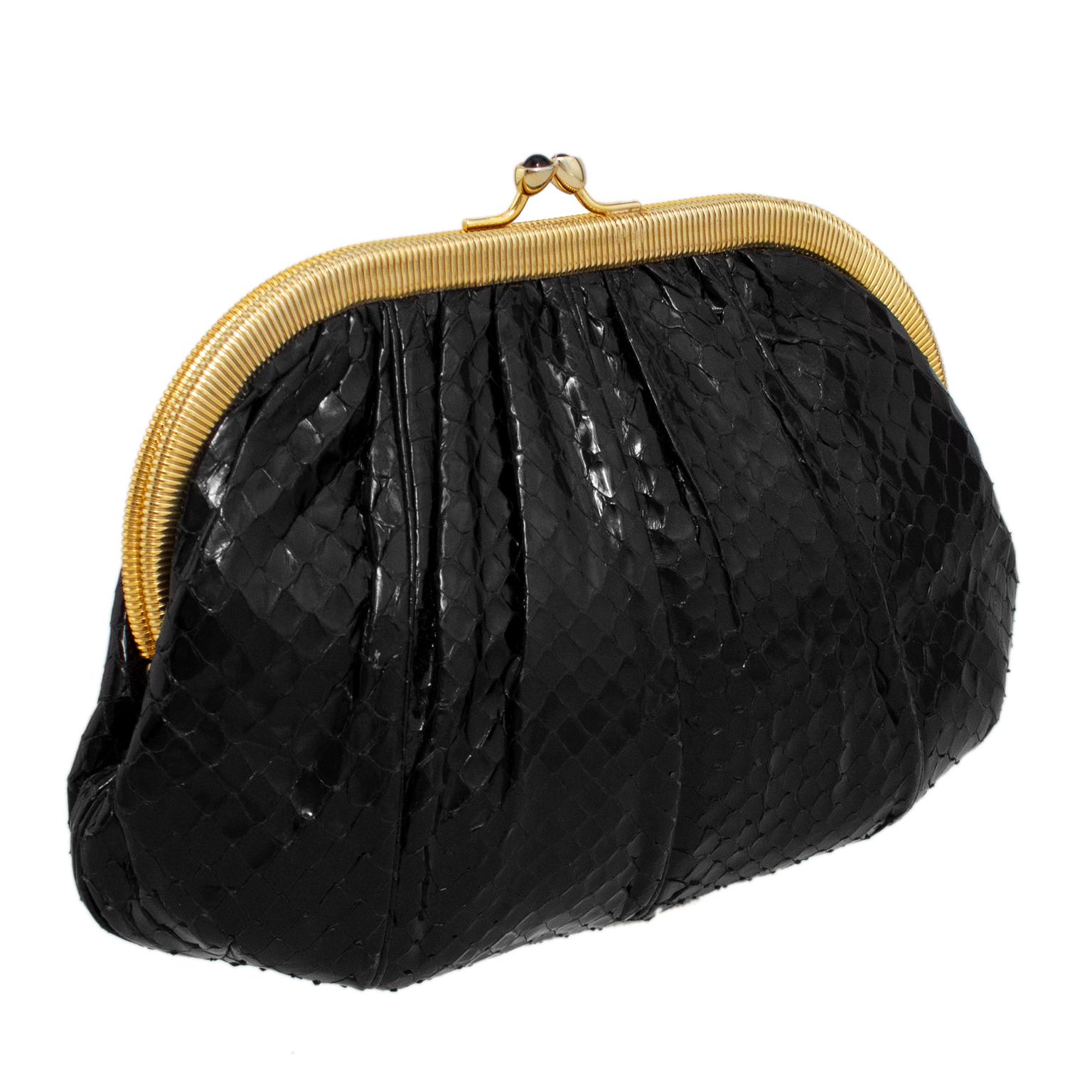 Stunning Judith Leiber evening clutch from the late 1980s. Back stamped leather with some gathering and seams that add dimension and texture. Frame style with a contrasting ribbed gold tone metal trim and kiss lock closure with small black