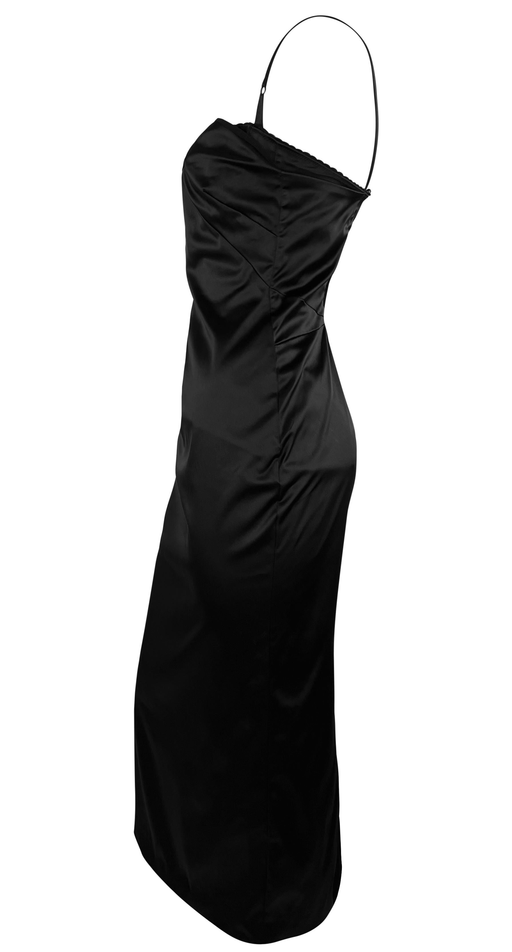 From the late 1990s, this black satin Dolce & Gabbana slip dress is the ultimate little black dress. This chic dress falls below the knee and features a built-in bodysuit, interior corset, and mesh lining. It has taut hook-and-eye closures at the