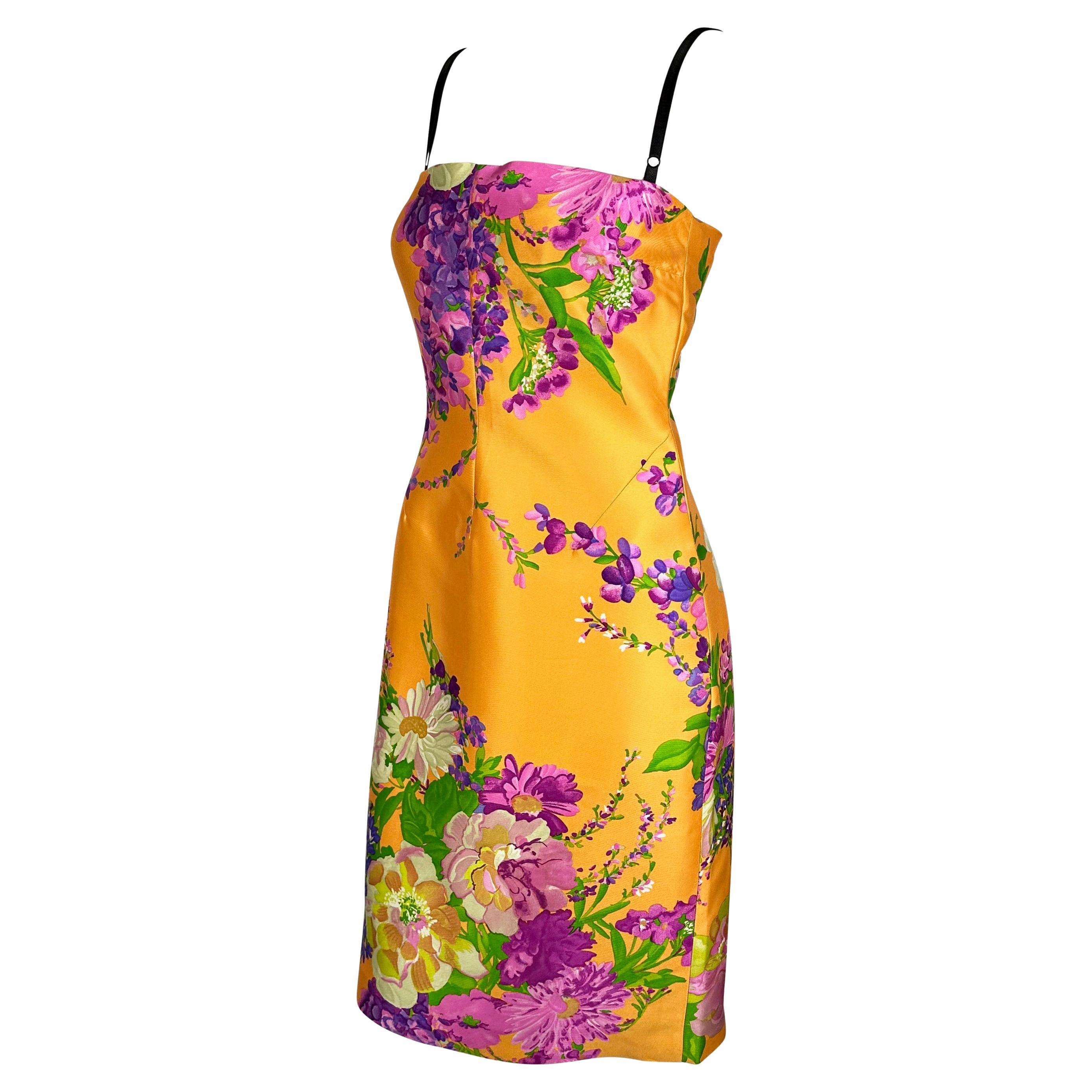 Presenting a fabulous vibrant orange floral Dolce and Gabbana Dress. From the Spring/Summer 2000 collection, this fabulous orange silk dress features a large multicolored flower print throughout. The dress is made complete with a built-in black lace