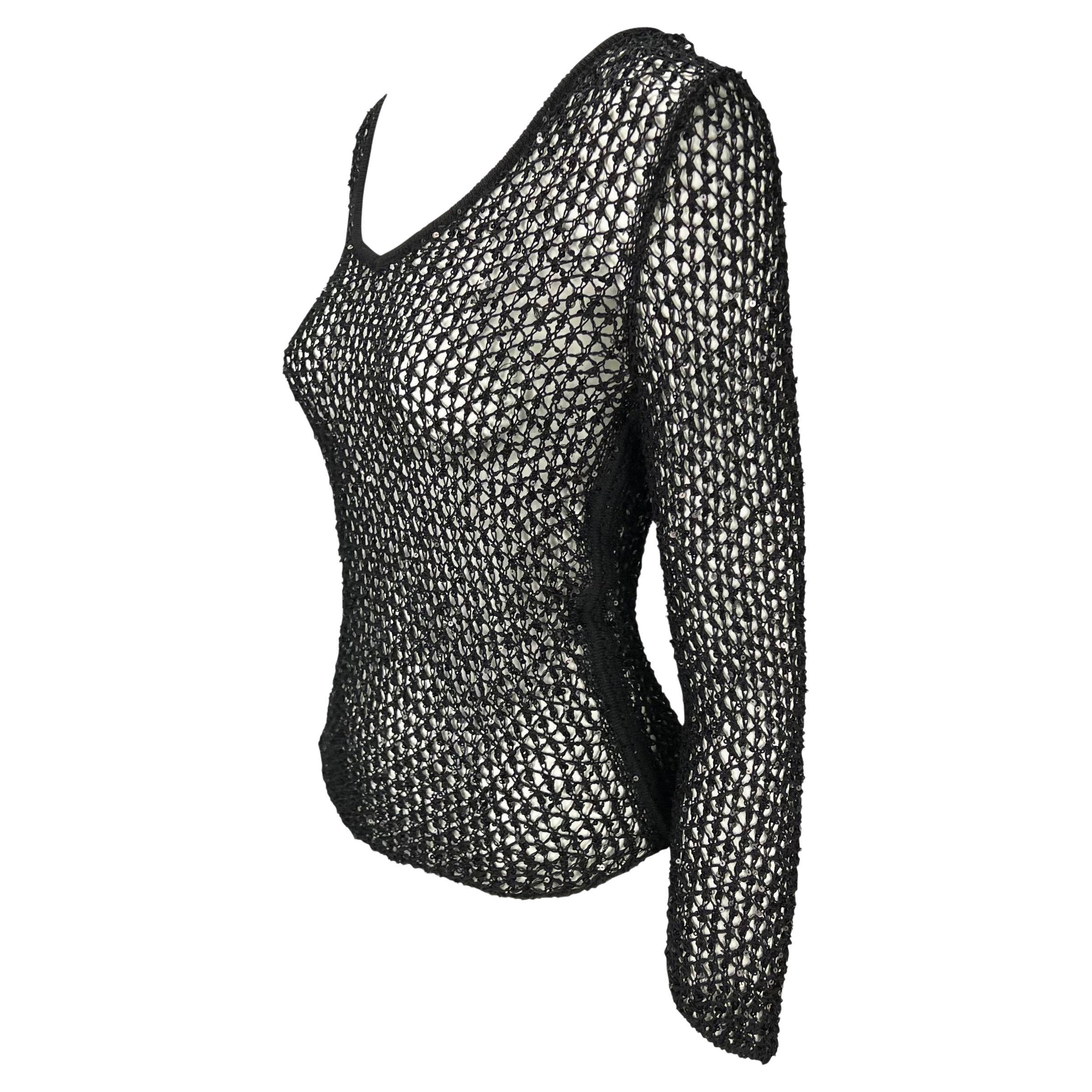 Presenting a black wide knit Gianni Versace sweater, designed by Donatella Versace. From the late 1990s, this fabulous top features a fishnet-like knit with sequins peppered throughout. The top is made complete with a wide neckline and cropped