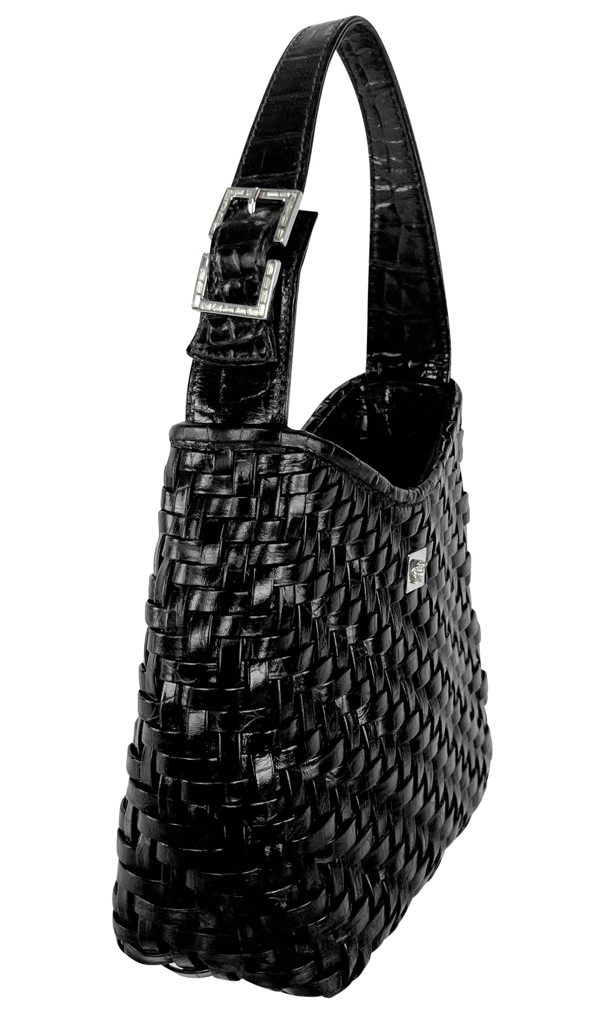 Donatella Versace designed this Gianni Versace mini tote crafted in black woven crocodile-embossed leather in the late 1990s. This compact style includes a single shoulder strap with a rhinestone encrusted buckle and is finished with a silver-tone