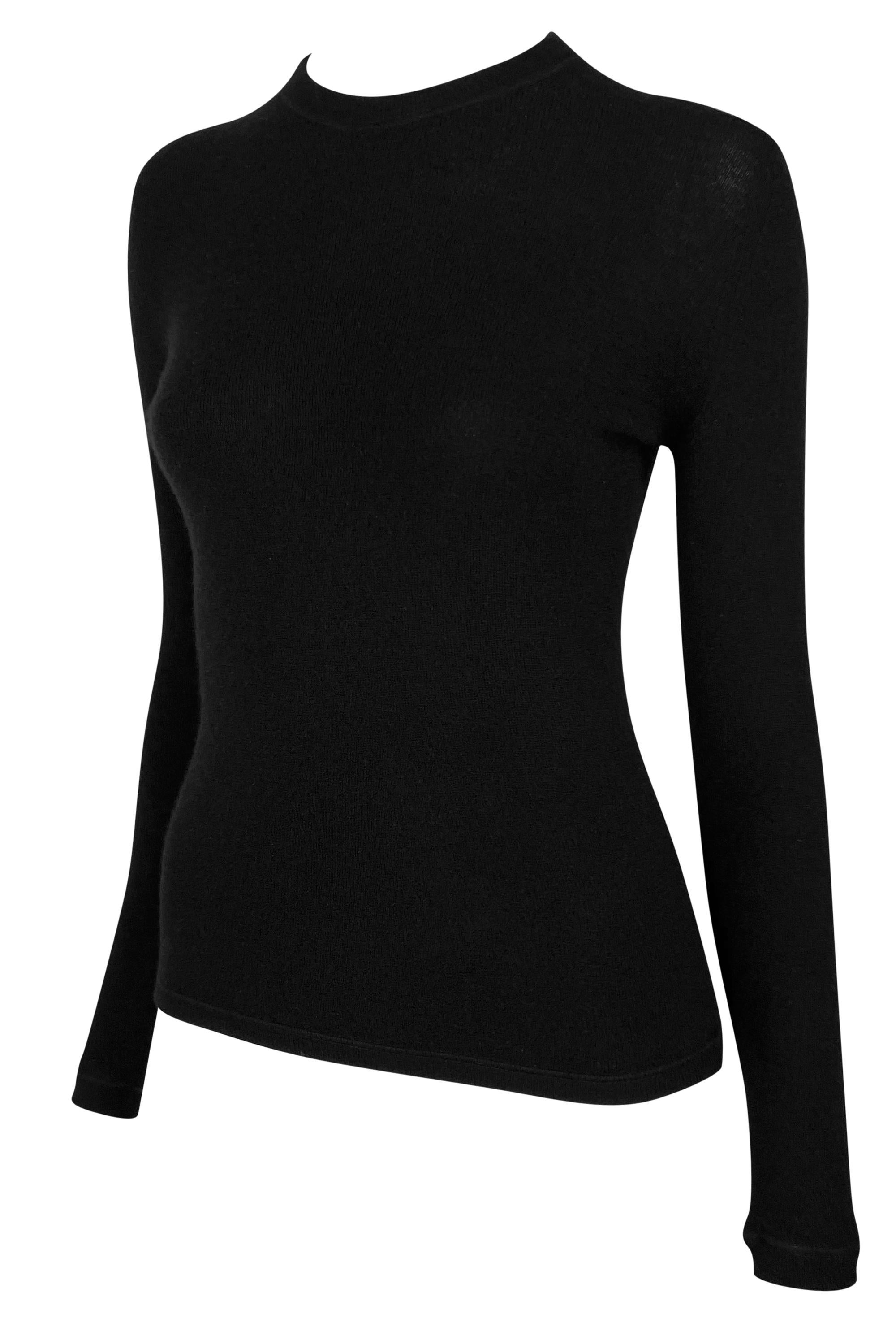 This late 1990s Gucci black knit sweater, designed by Tom Ford, is crafted from stretch cashmere for a slim, contoured fit. The design features a high, close-cut crew neckline and long fitted sleeves. 

Approximate measurements:
Size -