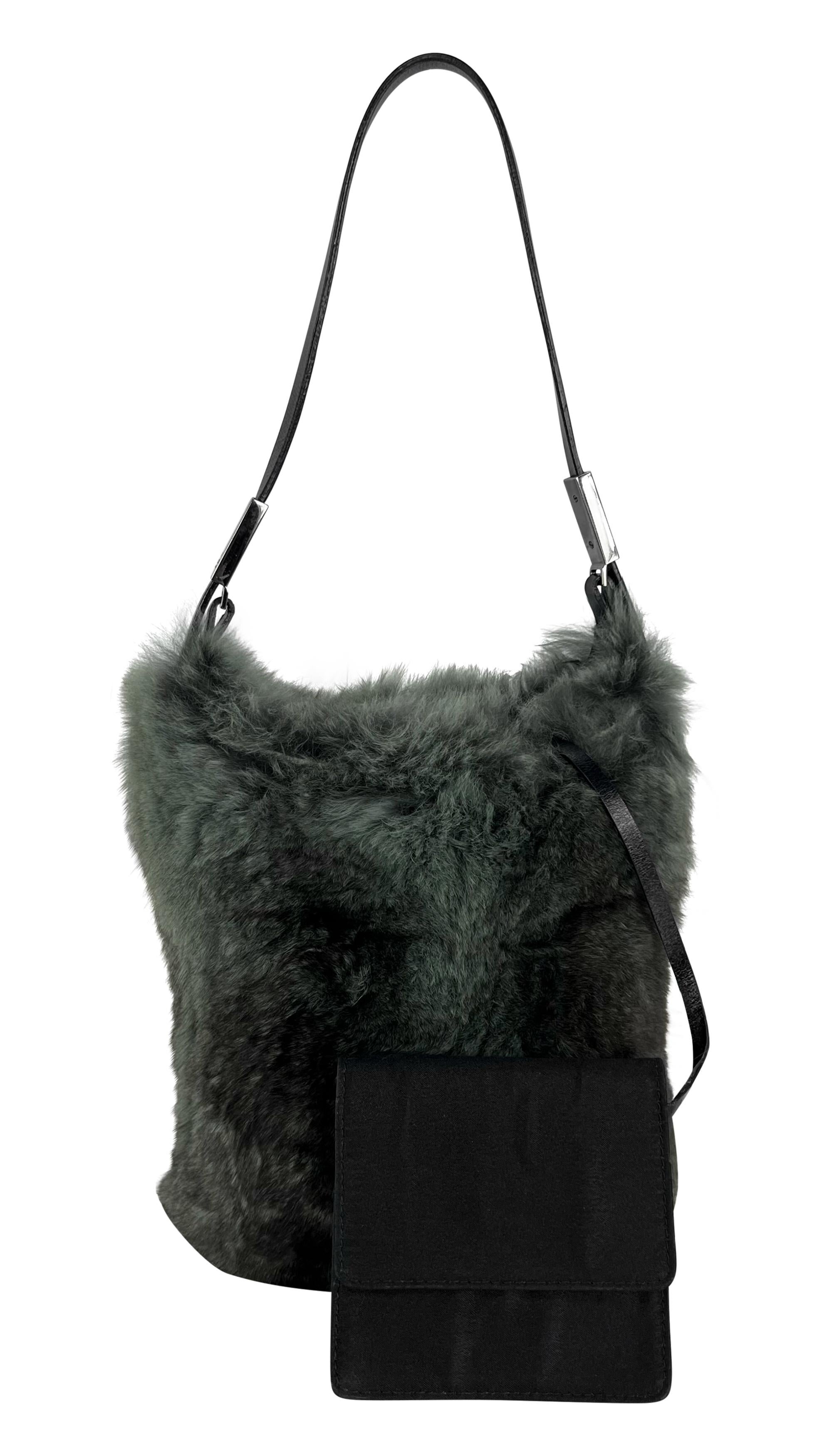 This late 1990s Gucci mini bag, designed under Tom Ford, features a luxuriously soft grey genuine lapin fur exterior. The bag has a single black leather shoulder strap, accented with silver-tone branded hardware

Approximate measurements:
Height: