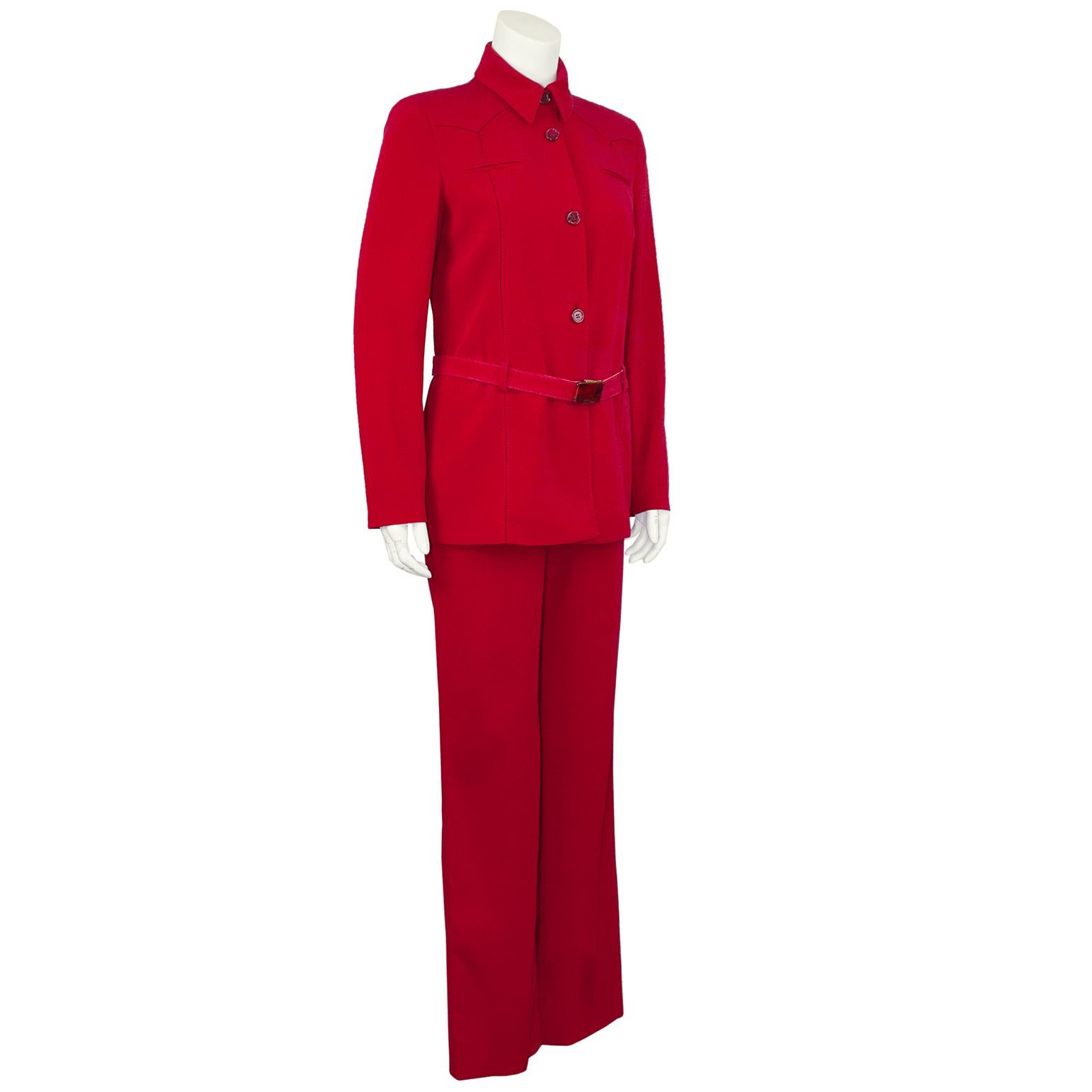 Iconic Prada red suit from the late 1990s. The Western style yoke detail on the jacket adds a touch of charm and it fastens with buttons down the front and a matching belt. The belt is secured to the waist with red belt loops and the buckle features