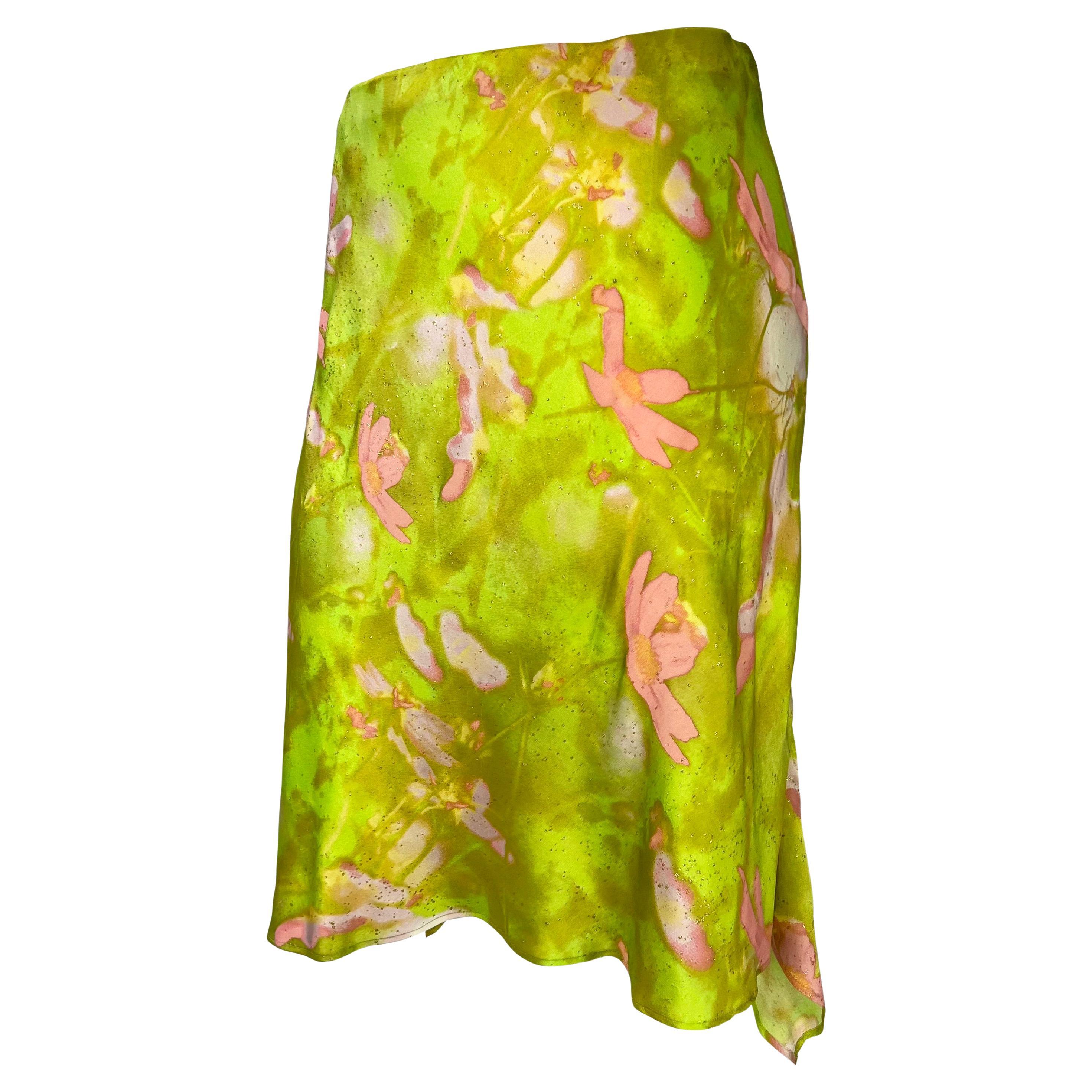 TheRealList presents: a chartreuse floral Roberto Cavalli skirt. From the late 1990s, this fabulous skirt features a flare cut and elastic waistband. The skirt is covered in a bright pink floral pattern with a chartreuse background and gold metallic