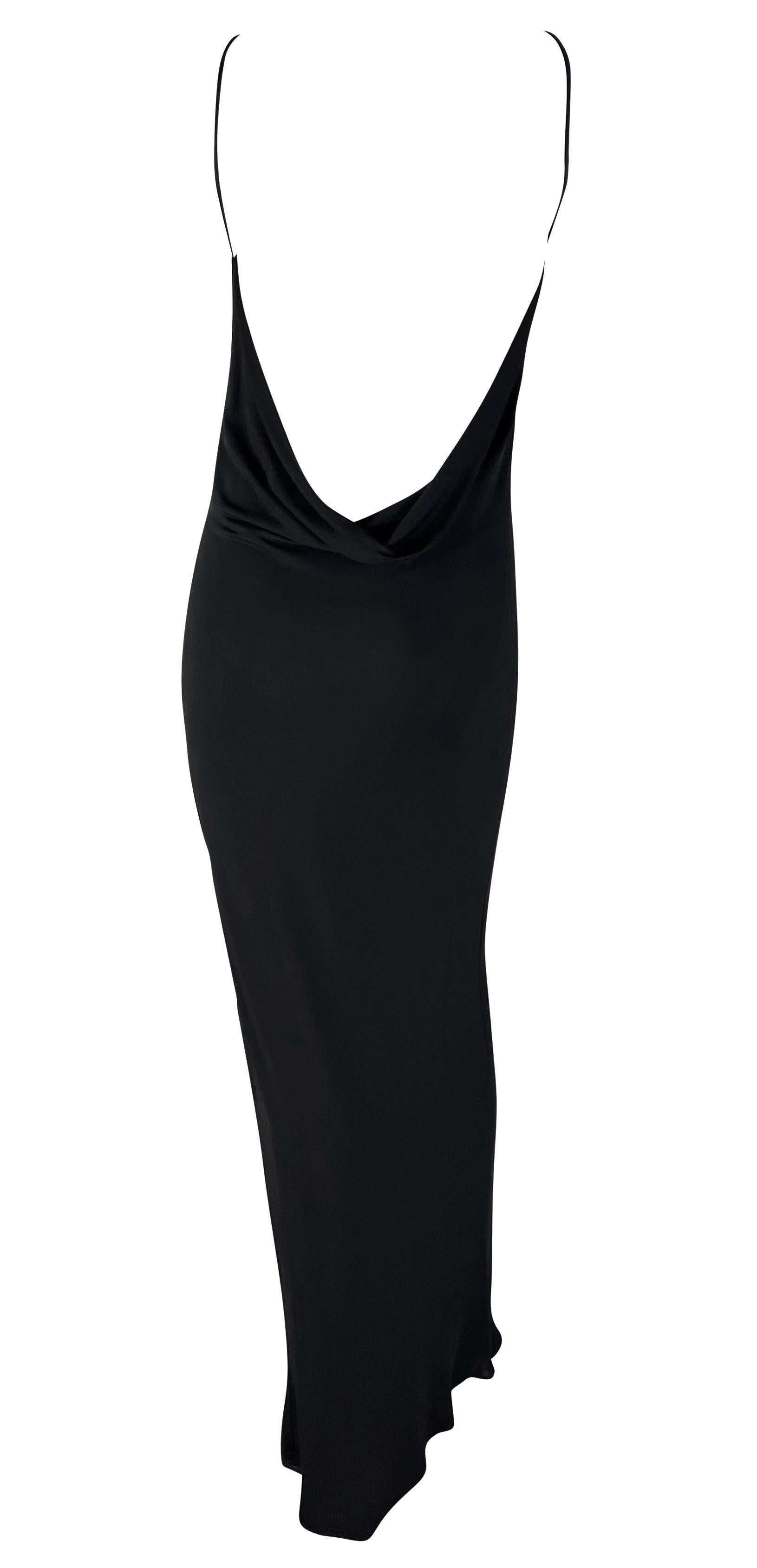This backless black gown by Israeli-American designer Yigal Azrouël, dating back to the late 1990s, epitomizes versatility. Whether for a formal occasion or a more casual event, this chic gown fits the bill. It boasts a high, wide neckline and a