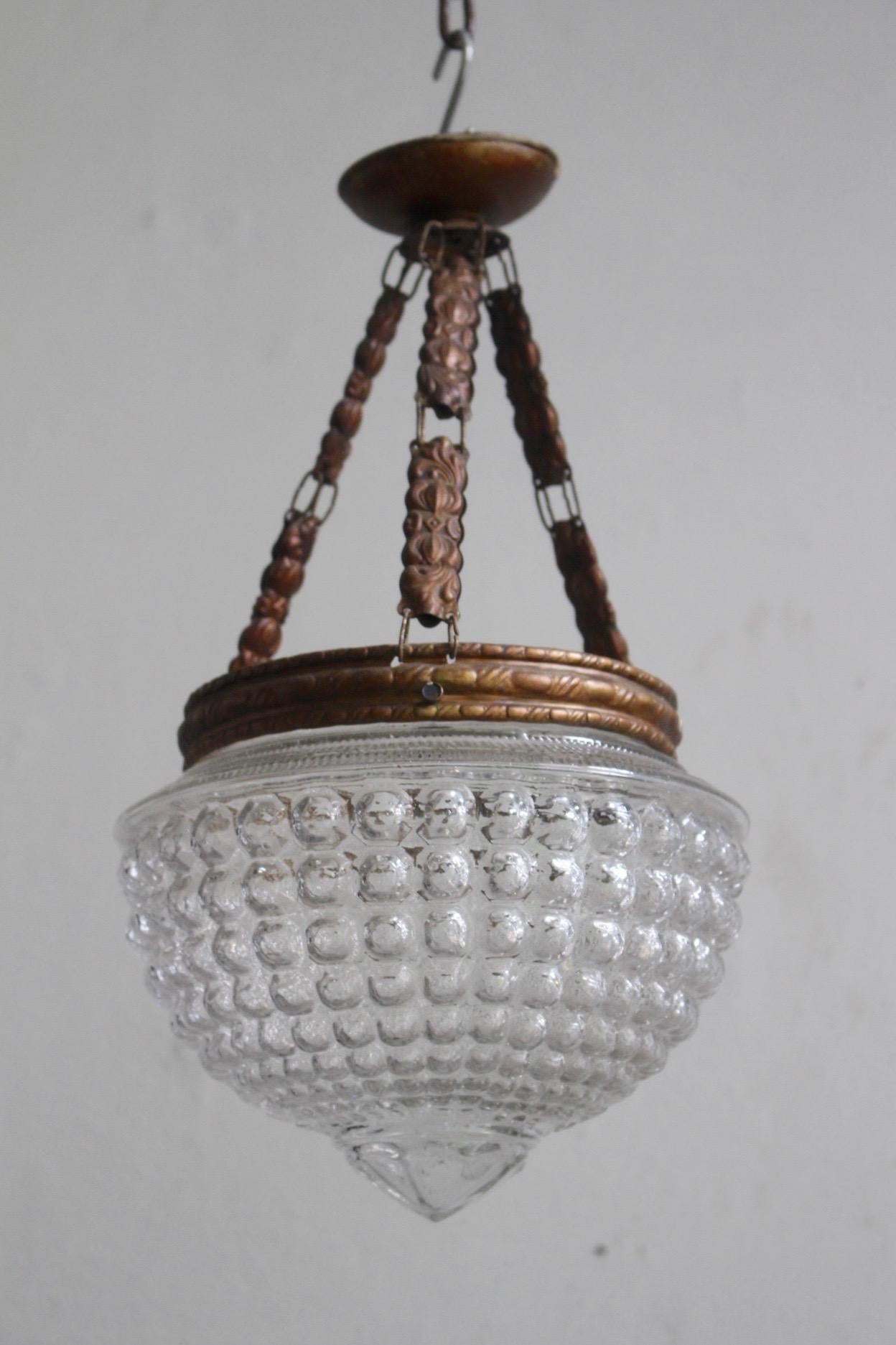 Late 19th antique Art Nouveau pendant lamp with geometric bubble glass and original chains with beautiful light copper color patina in good antique condition.
