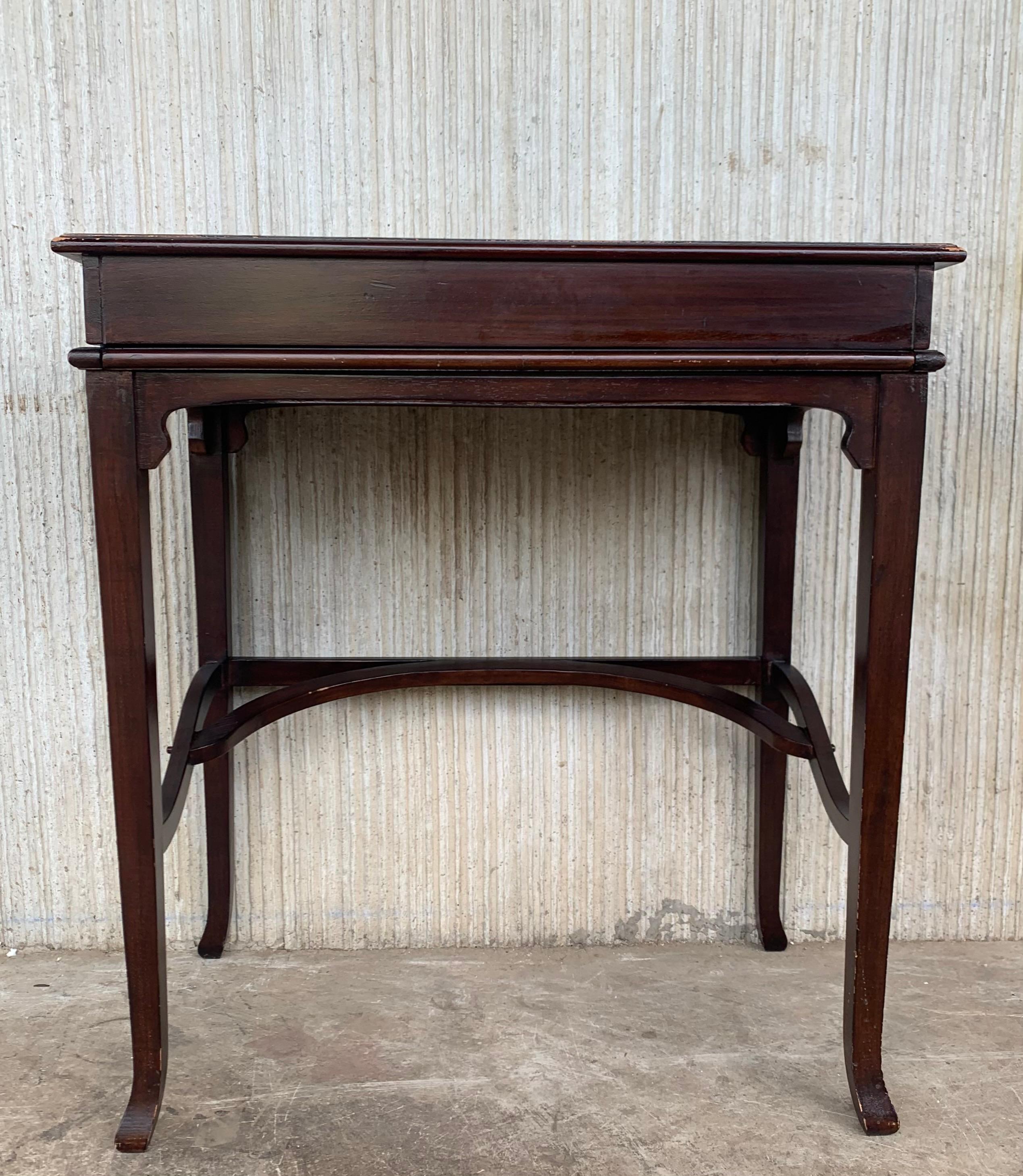 An Italian smaller-sized writing desk with storage hidden beneath top from the 19th century. This super cute desk, or occasional table from Italy, with simply lines. The top of this piece slides back across the top, revealing storage and open