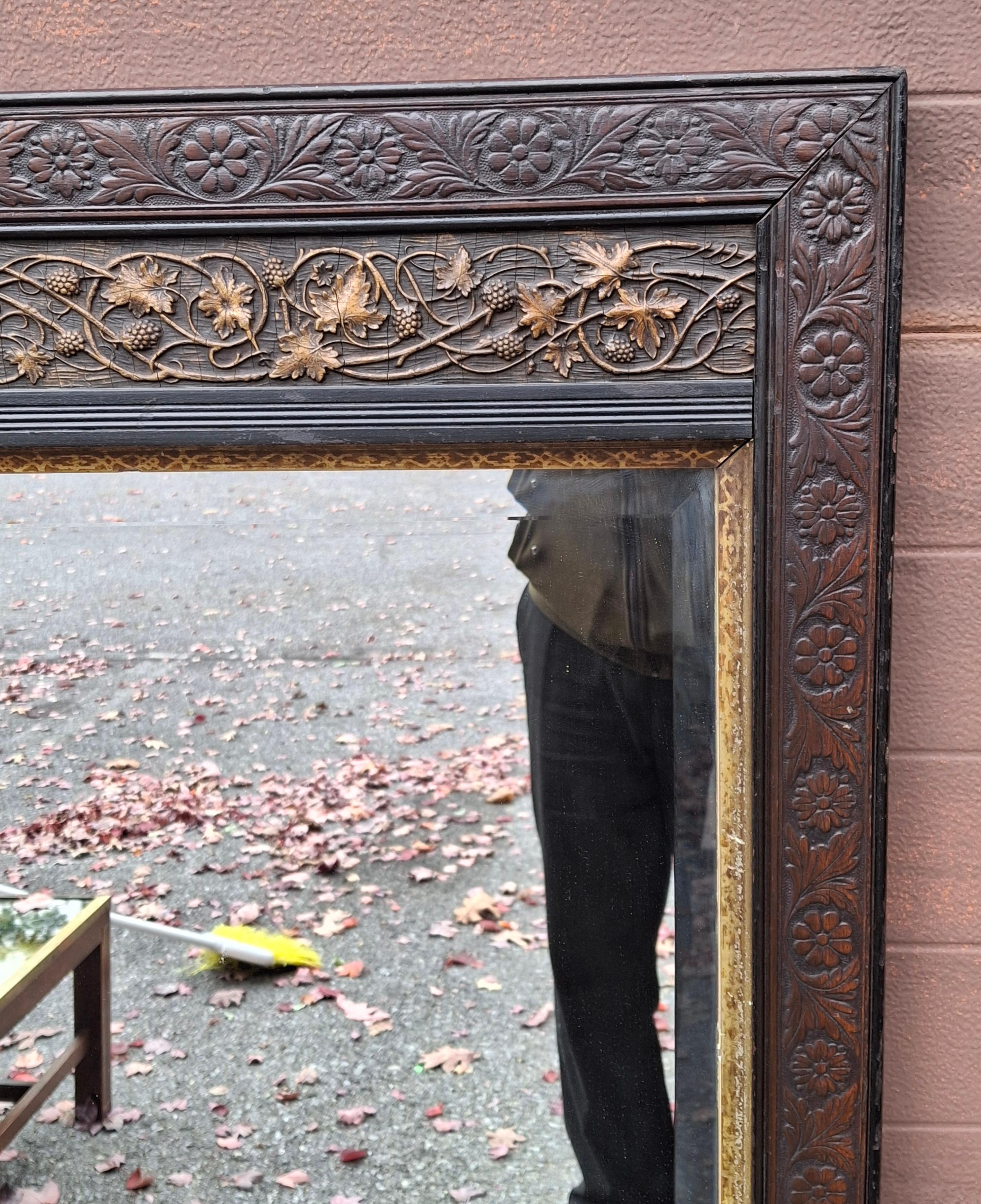 A Late 19th Century Aesthetic Movement Carved Mahogany and Parcel Gilt Frame Mirror.
Measures 25.25
