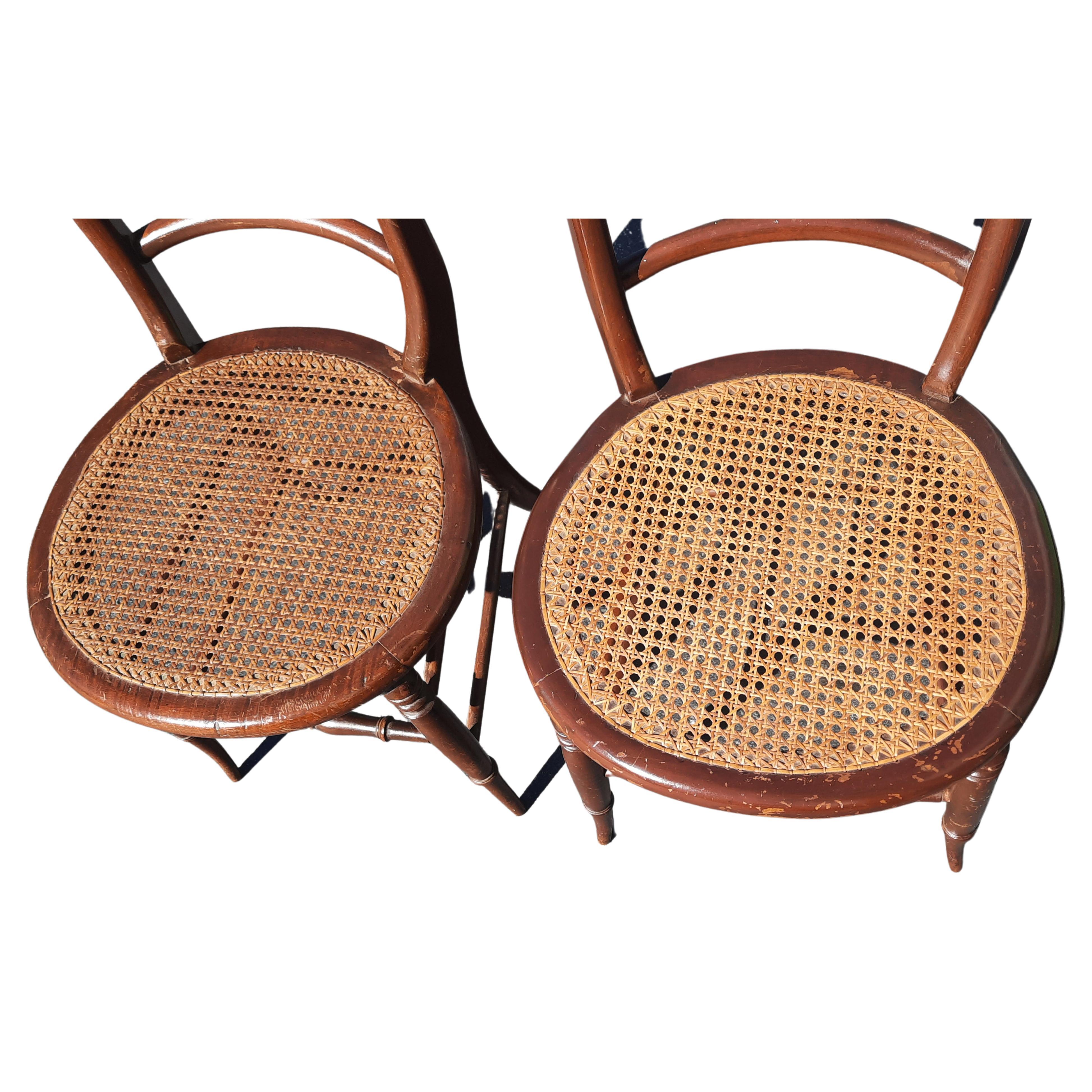Add these two antique hand-crafted, cane-seat mahogany side chairs to your MCM décor.
Same chairs found in 1889 Sheboygan Chair Co, Sheboygan, WI, catalog.
Curved 2-rung ladder back; subtle shaped back leg extends up side back. Turned front legs