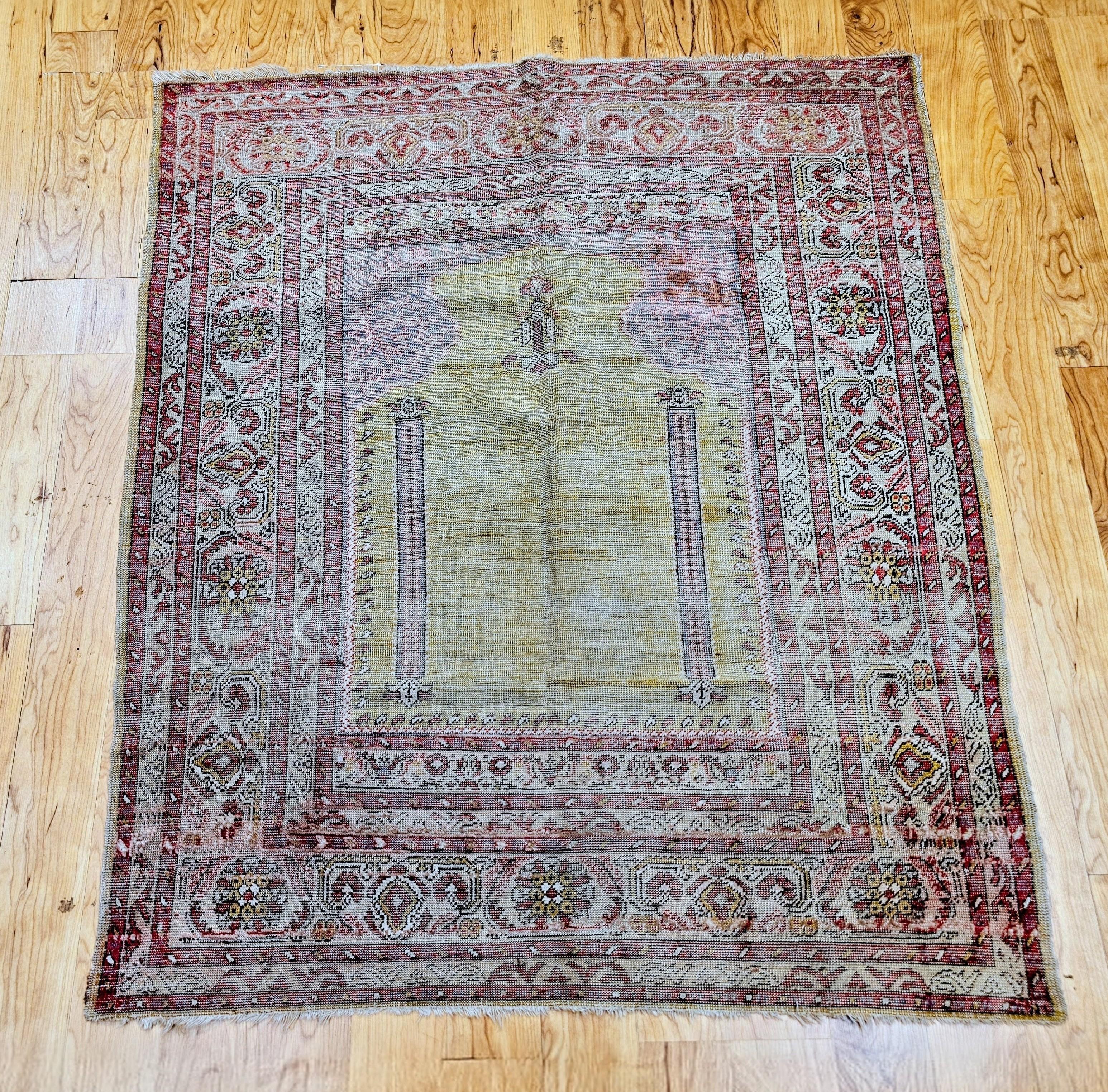 An exceptional late 19th-century Anatolian Turkish village rug in the traditional prayer (Mihrab) design, masterfully handwoven with organic vegetable-dyed wool. The serene pale yellow-green central field features a graceful two-column composition,