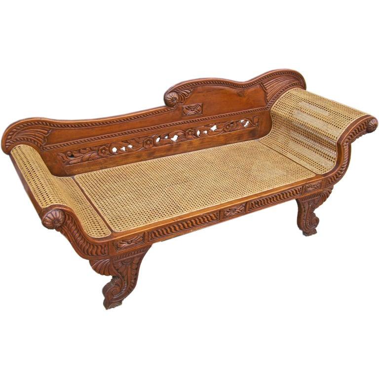 This East Indies carved mahogany and handed caned recamier was made in the late 19th century.