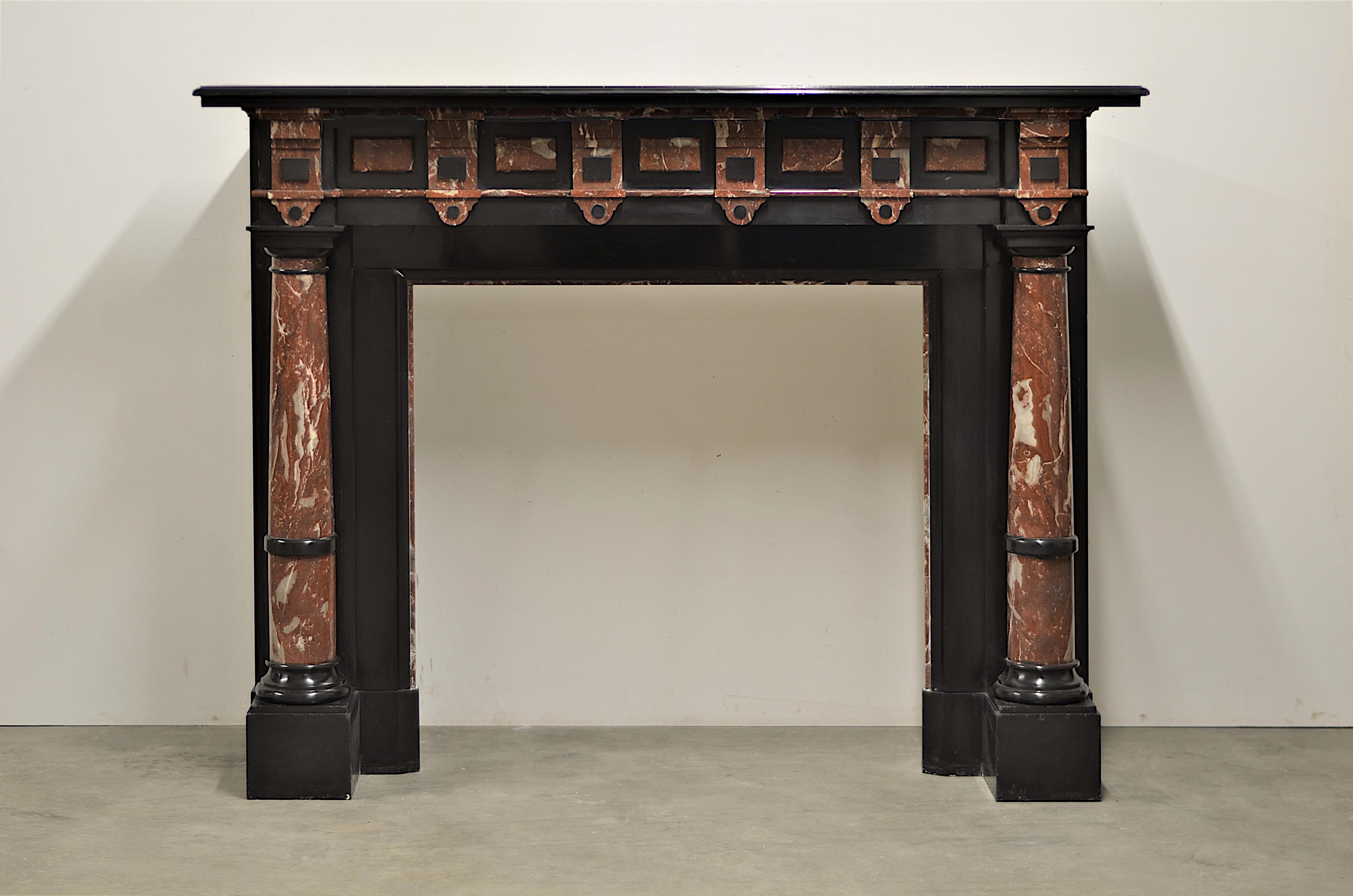 A nice and tall late 19th century black marble fireplace with beautiful red decorations and columns.
This impressive mantel came from a nice mansions on the outskirts of The Hague, NL.

Its almost square opening makes it perfect suitable for