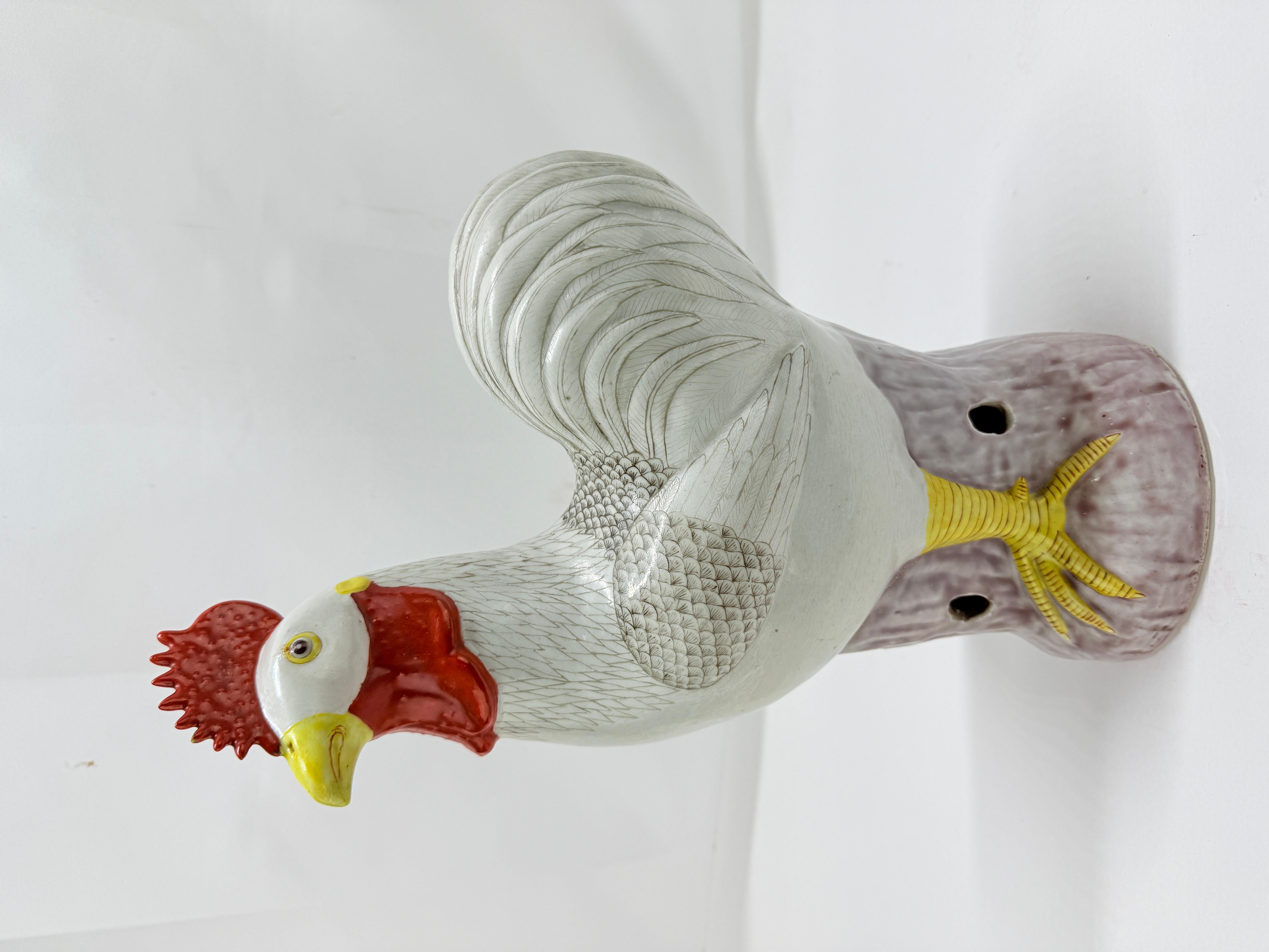 A finely modeled and vividly enameled Chinese export style porcelain figure of a rooster, dating to the late Qing Dynasty or early Republic period, circa 1880–1920. The rooster stands alert on a tree-stump form base glazed in pale aubergine and