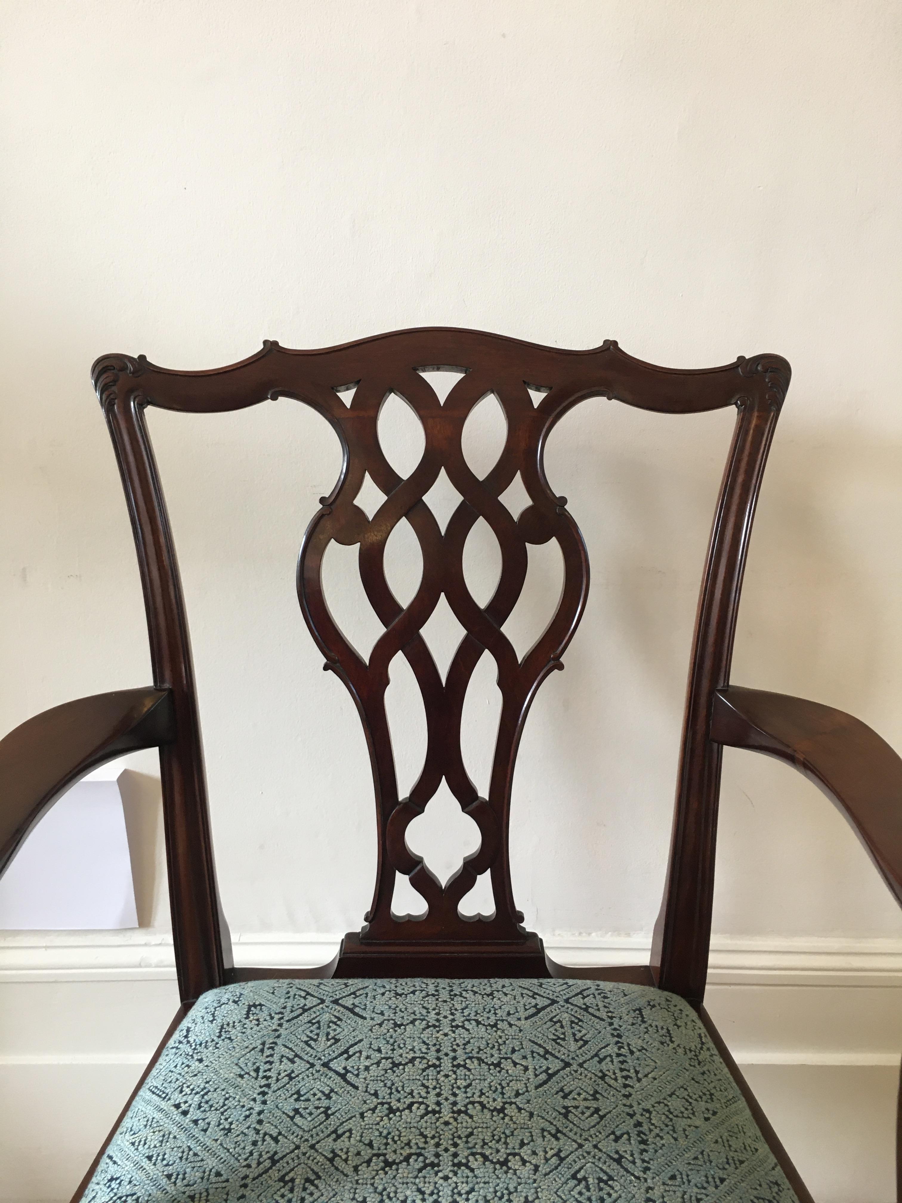 This very handsome and exceptional quality mahogany armchair is in the Chippendale style with a blueish green patterned upholstered drop in seat. The chair has a very small old repair on the underside of the arm, shown in one of the photographs. It