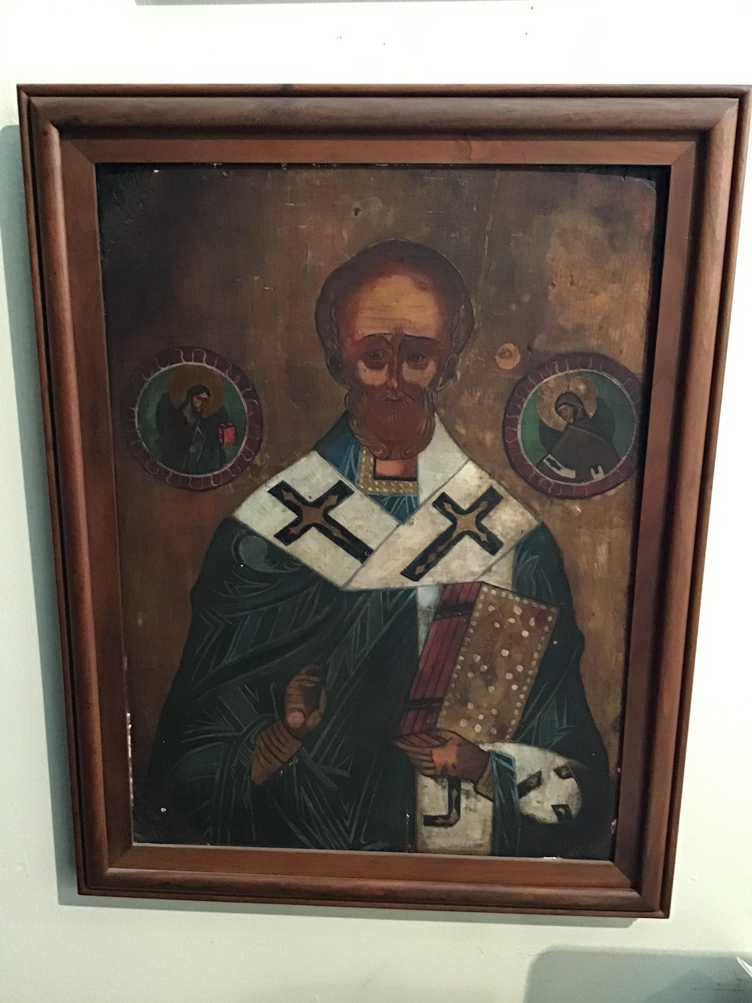 Late 19th C. Eastern European Icon of St. Gregory. Painted on a panel composed of two boards joined together with two battens, top and bottom. The wood appears to be either pine or fir and has knots and old worming with losses filled in at the
