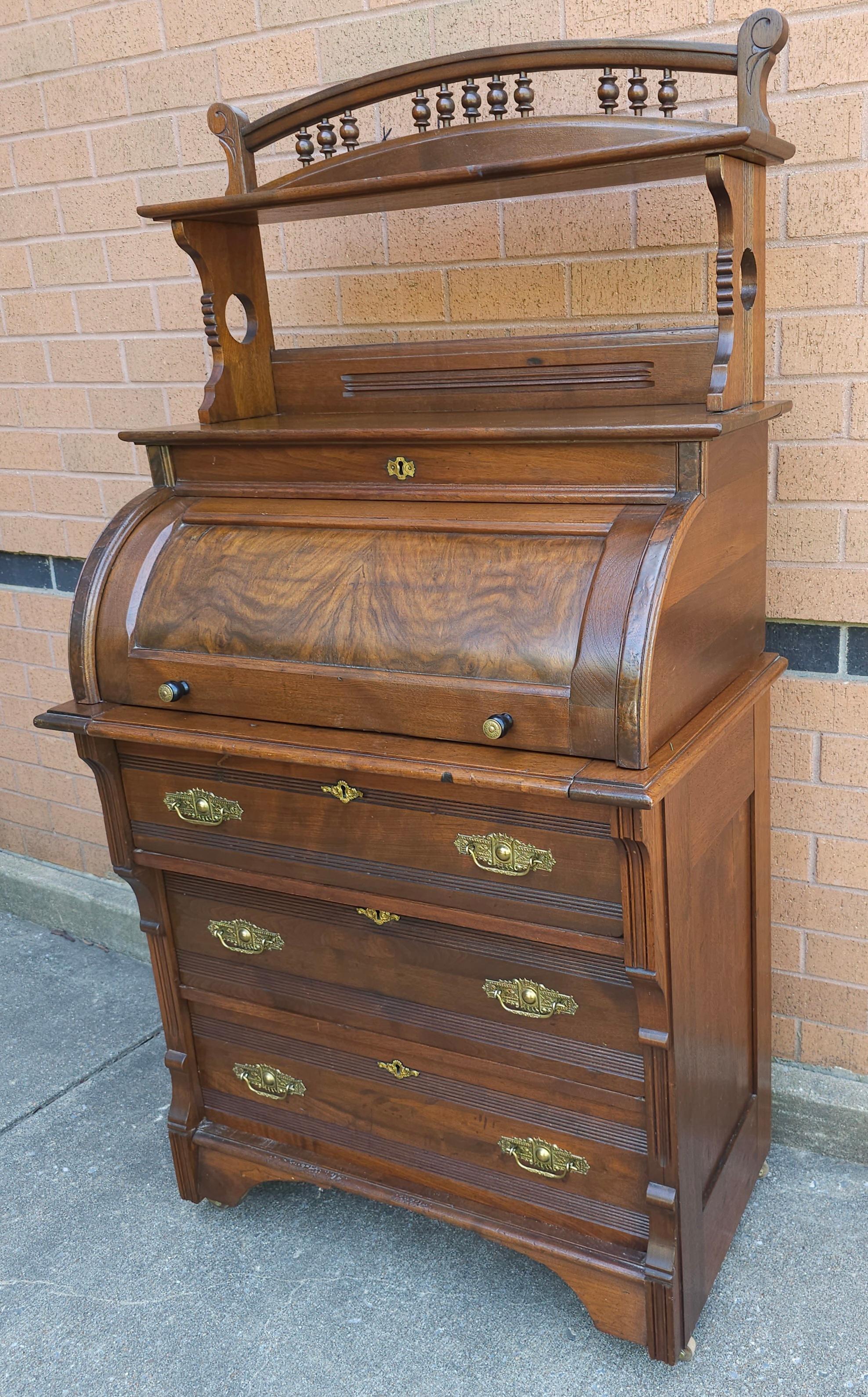 A Late 19th Century Four-Part Handcrafted Victorian Walnut Cylinder Front Rolling Desk with felt lined pull out tray. On original wooden wheels. Easily breaks down in parts to facilitate handling. Light weigh. Measures 32