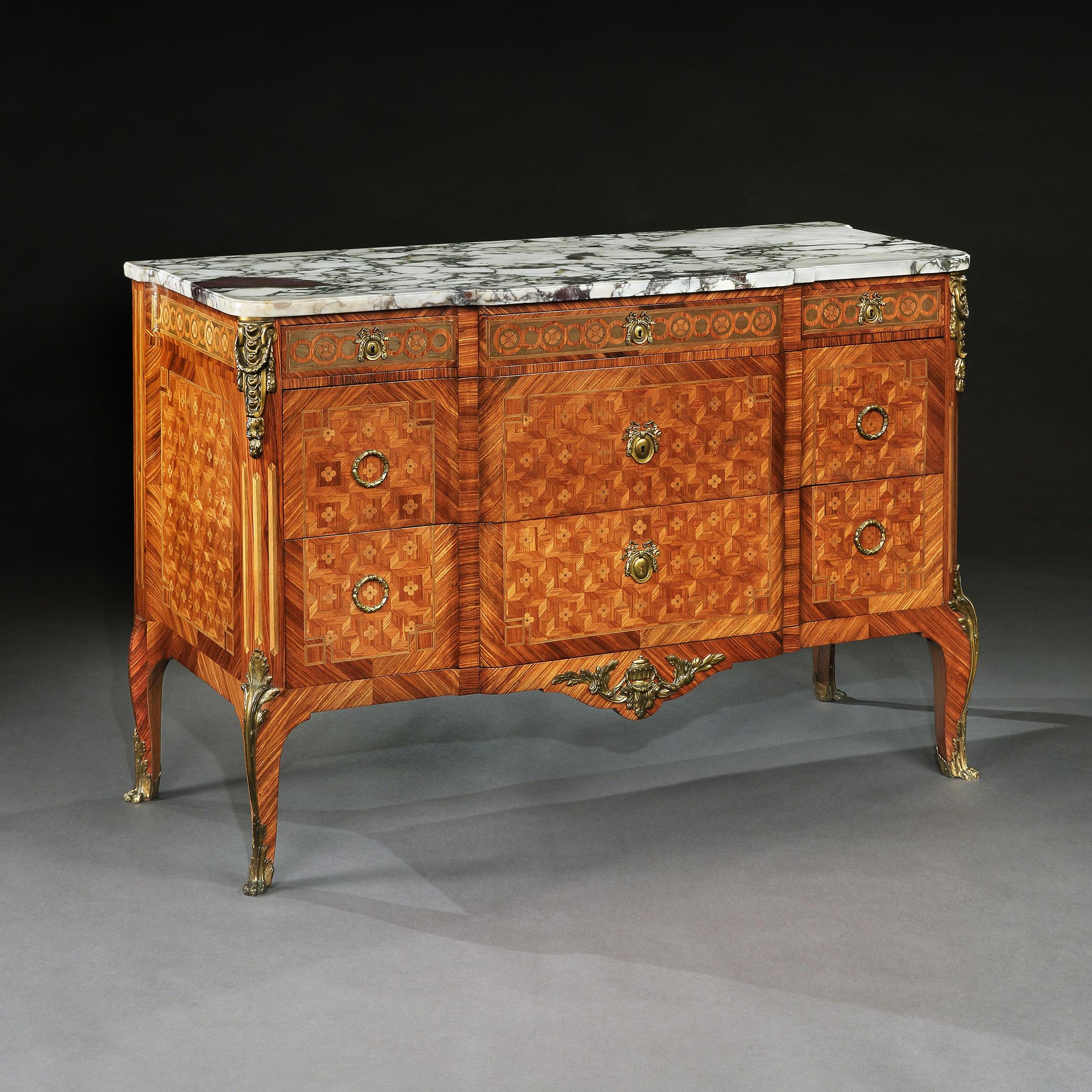 An outstanding gilt bronze-mounted tulipwood, kingwood and sycamore parquetry breakfronted breche violet marble topped commode, in French Transitional style dating to the late 19th-early 20th century.

French, circa 1880-1900.

Of superb