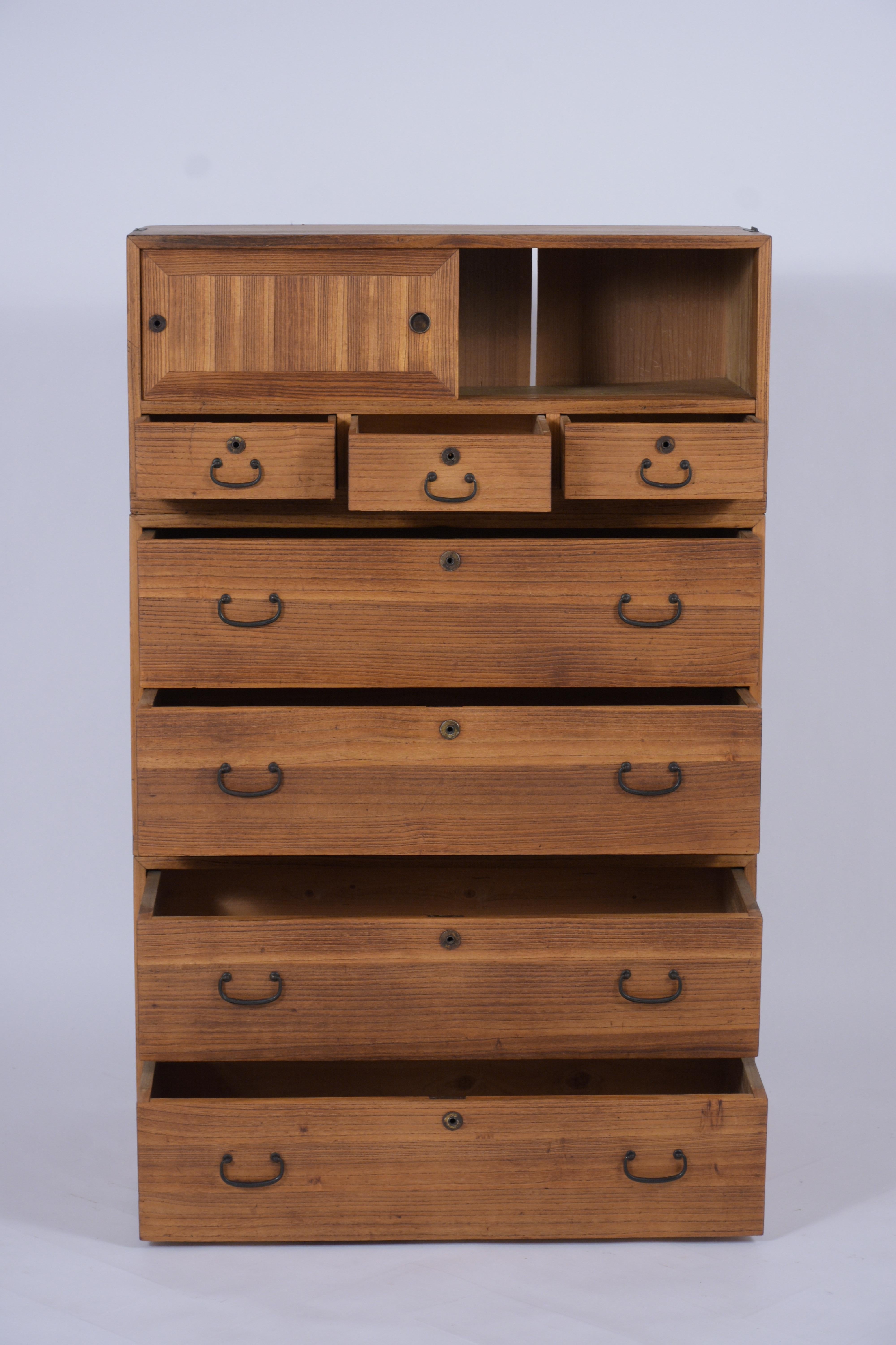 This Antique Kimono Tansu 3 section stackable cabinet is made out of Kiri wood with beautiful natural wood color and waxed patina finish. The top has two small slide doors with three small drawers below and rest on two sectionals with two large