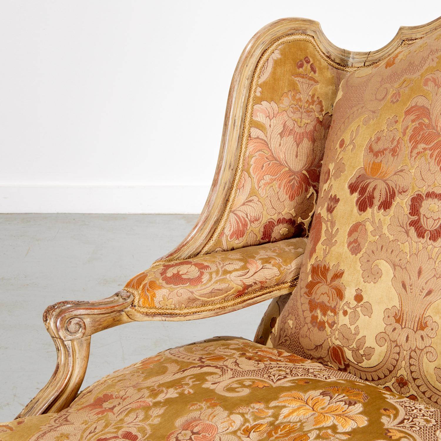 France, late 19th to early 20th century
Likely by a Parisian atelier in the manner of Maison Jansen or Maison Krieger

Dimensions: 41.5″ H × 32.25″ W × 25″ D

A handsome French Louis XV-style painted fauteuil à oreilles (“wingback armchair”), with