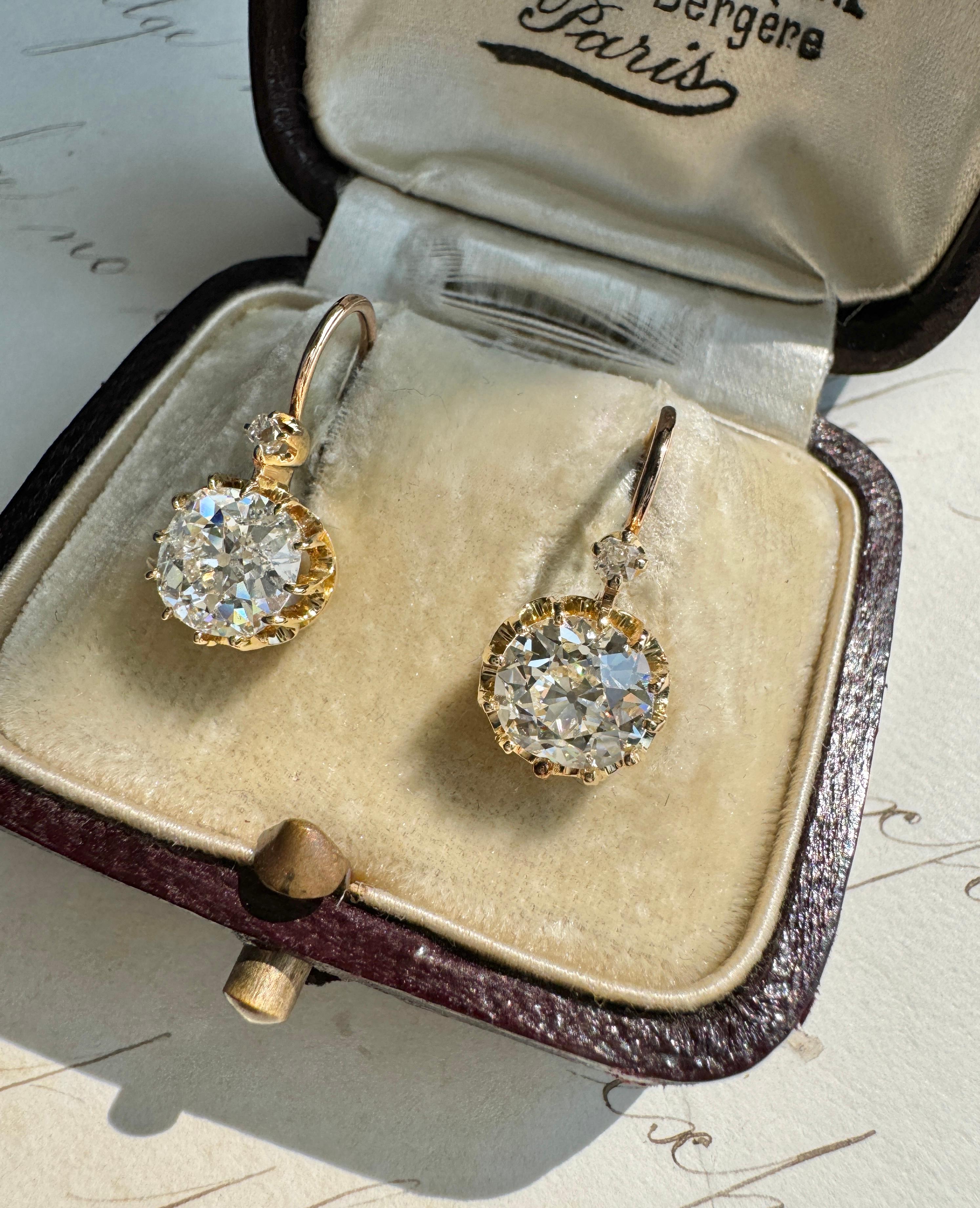 Elegantly hand fabricated in gleaming 14k rose gold in the late 19th century, these delightful ear drops hold a beautifully matched pair of scintillating old cut diamonds, together weighing 2.95 carats. Held high in slender prongs allowing lots of