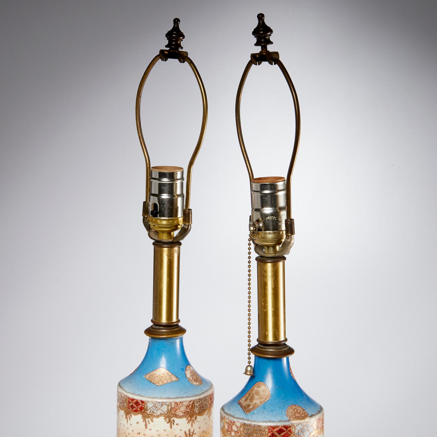 Late 19th pair of Japanese Satsuma vase table lamps, decorated with Japanese warriors., with floral and gold accents. Possibly Meiji period. This pair of columnar lamps, with a brass base, socket and harp, has an overall attractive appearance.
