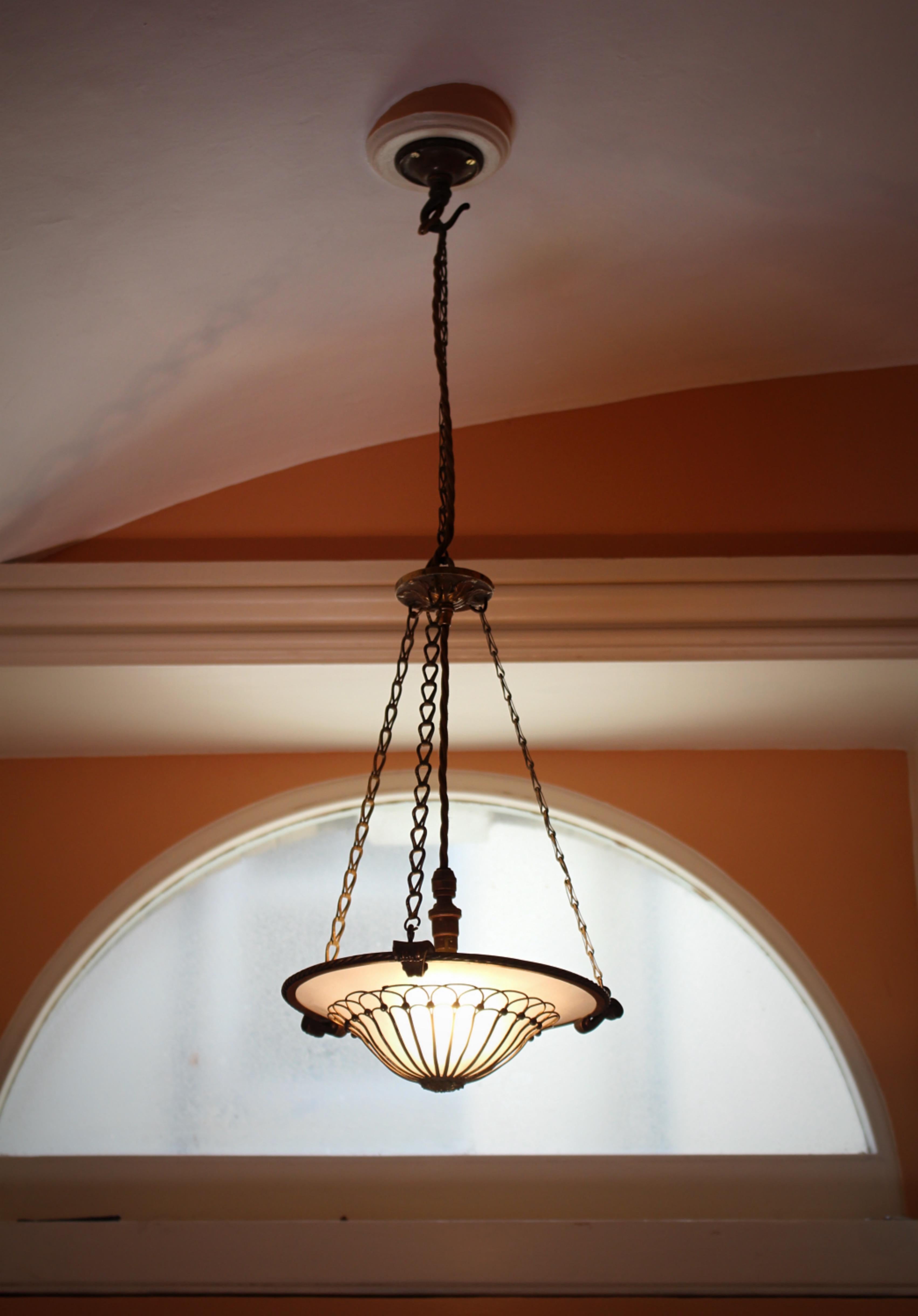 A beautiful and petite Faraday plafoniere pendant, the original frosted glass has an applied gilt brass decoration, housed in a gilt brass ring with its original 3 to 1 chandelier hook.

The pendant comes with a pigmy bayonet bulb holder, three core