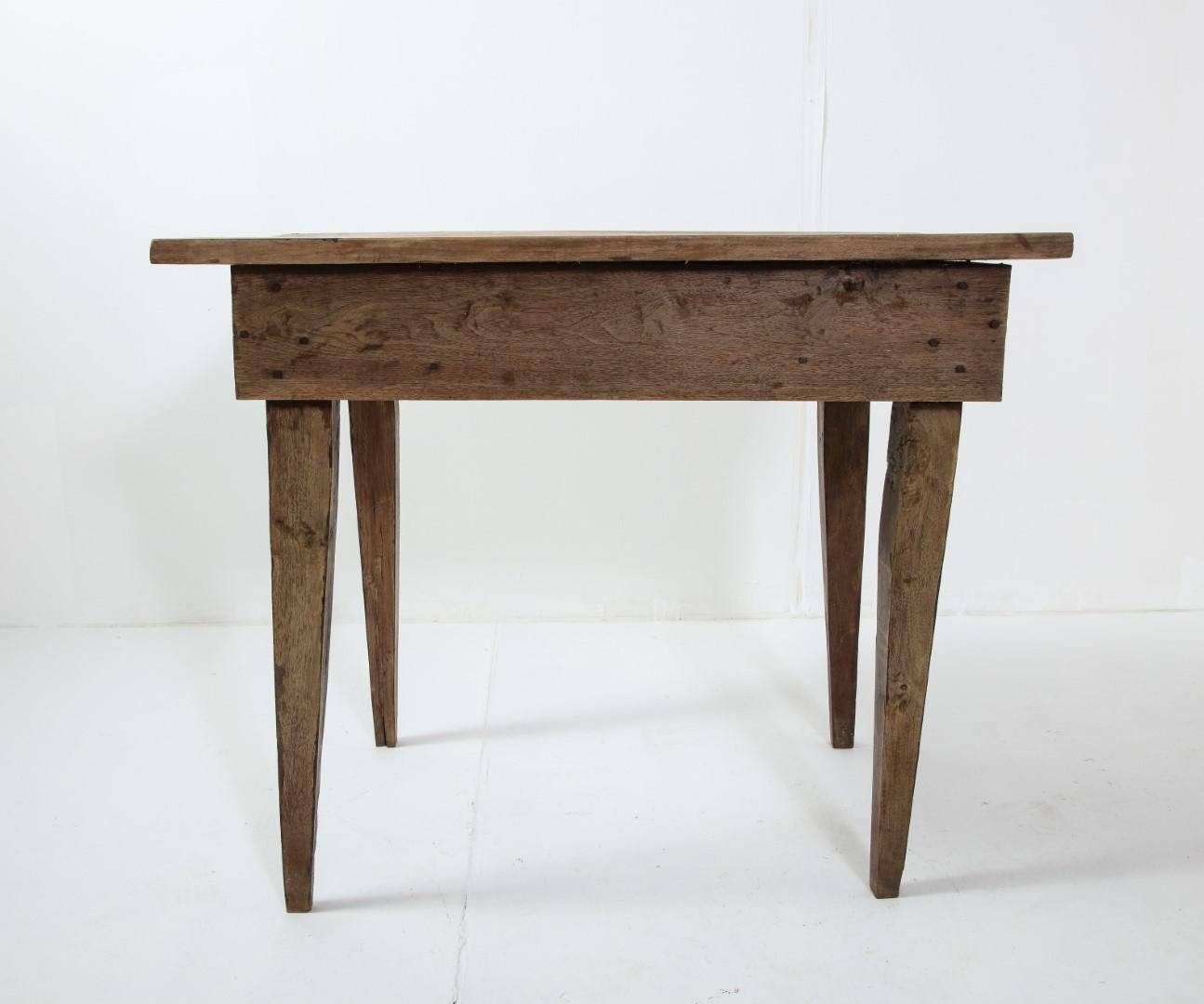 Late 19th century rustic oak side table with drawer and tapered legs. Original cast bronze handle is somewhat loose.
