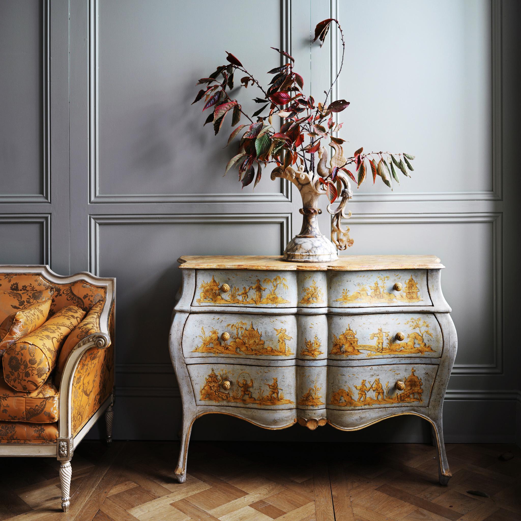A late 19th century, Venetian chest of drawers with a curvaceous bombe style shape that plays with the light at all angles. The hand painted finish is in the Chinoiserie style featuring a luminous palette of a celeste blue and yellow ochres. The top