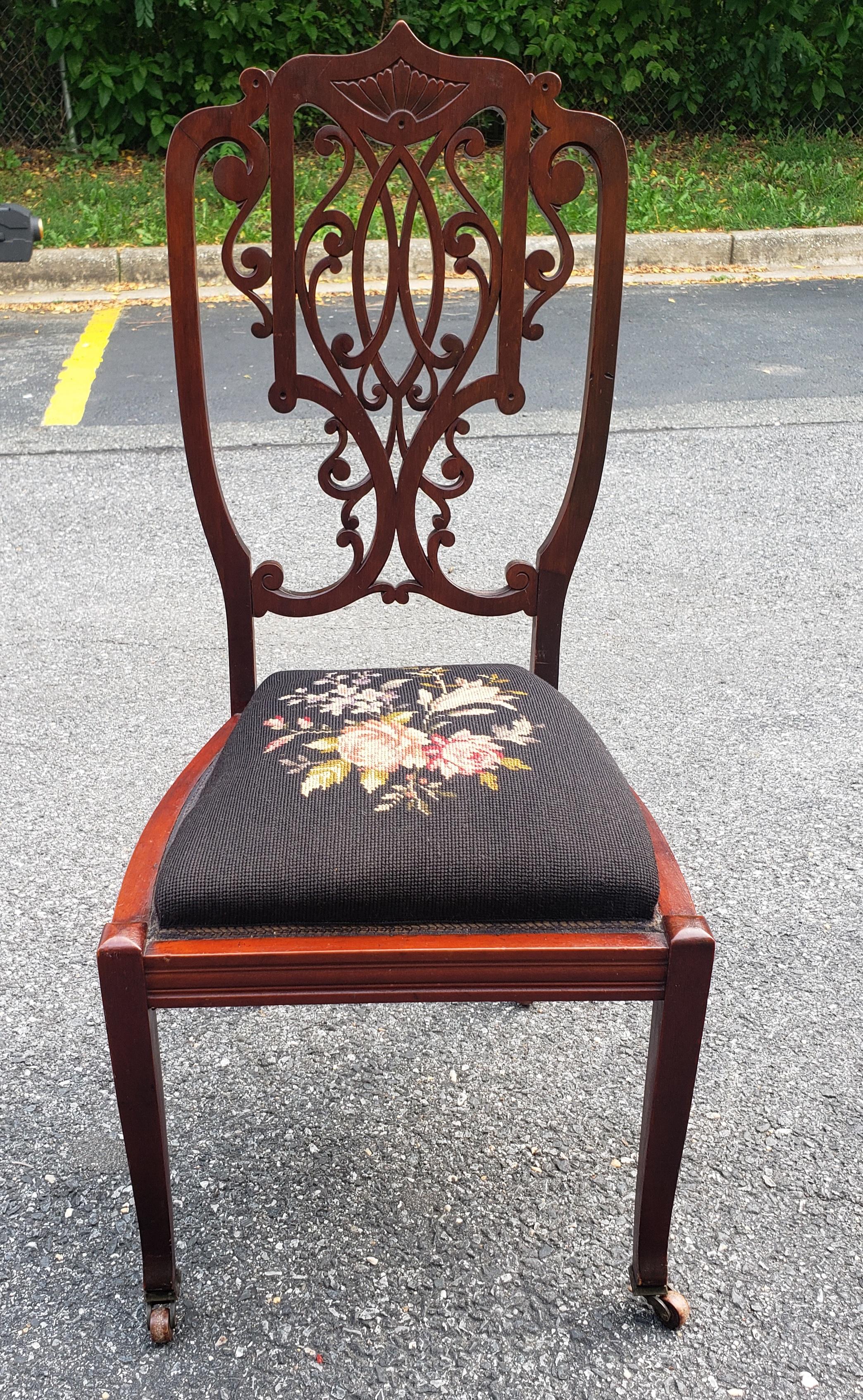 A Late 19th C. Victorian Mahogany and Needlepoint Upholstered Side Chair on Wheels in very good antique condition.