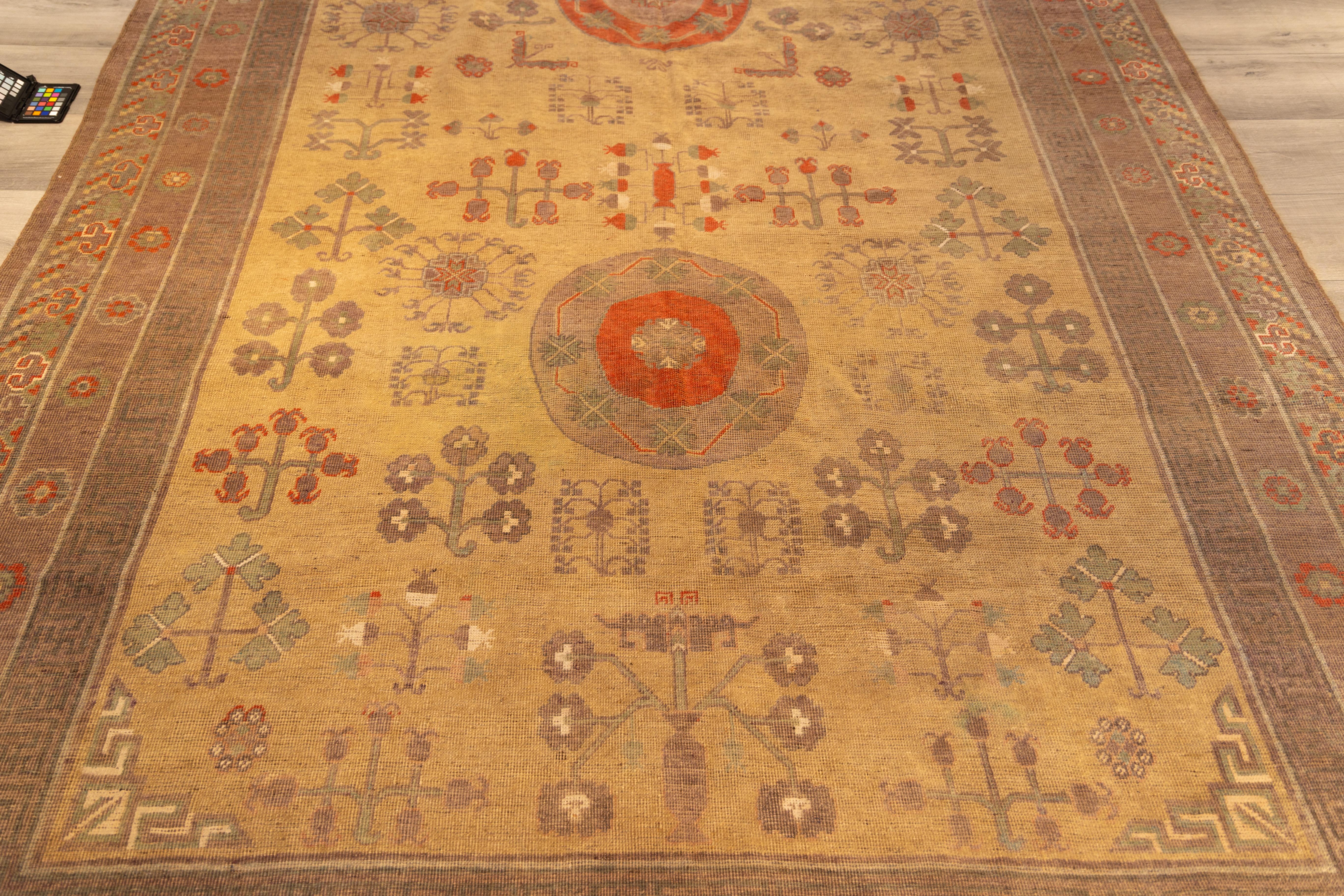 late 19th century very decorative  Khotan. 
the yellow central field is decorated with three medallions flanked by all over pomegranate design and a beautiful purple border