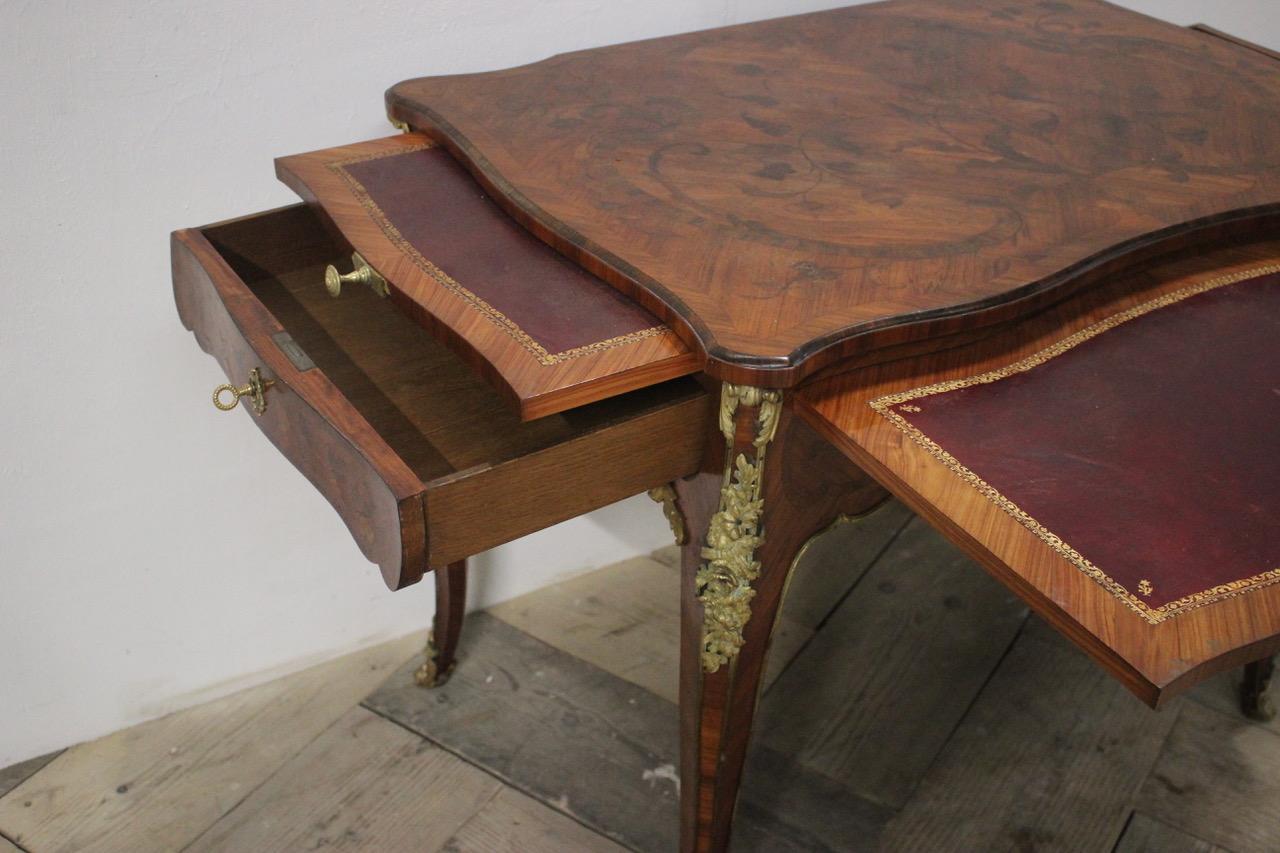 A good quality, late 19th century French Kingwood and Tulipwood marquetry dressing / writting table in the Louis XV taste, with fine quality ormolu mounts, two drawers and two brushing slides on the sides. 

Measurements: 60cm high (knee height)
