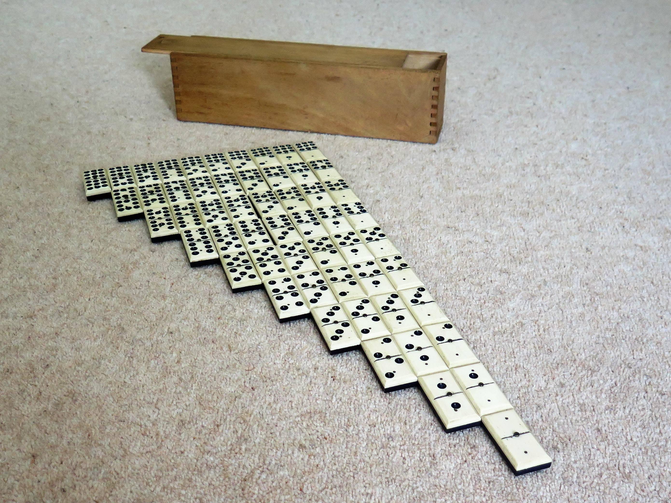 This is a rare and original '9 Spot' Dominoe game of 55 individual dominoes, coming complete with its jointed wooden box or case.

Dominoe sets are normally six-spot sets giving a total of 28 dominoes.
This set is much rarer, having a full