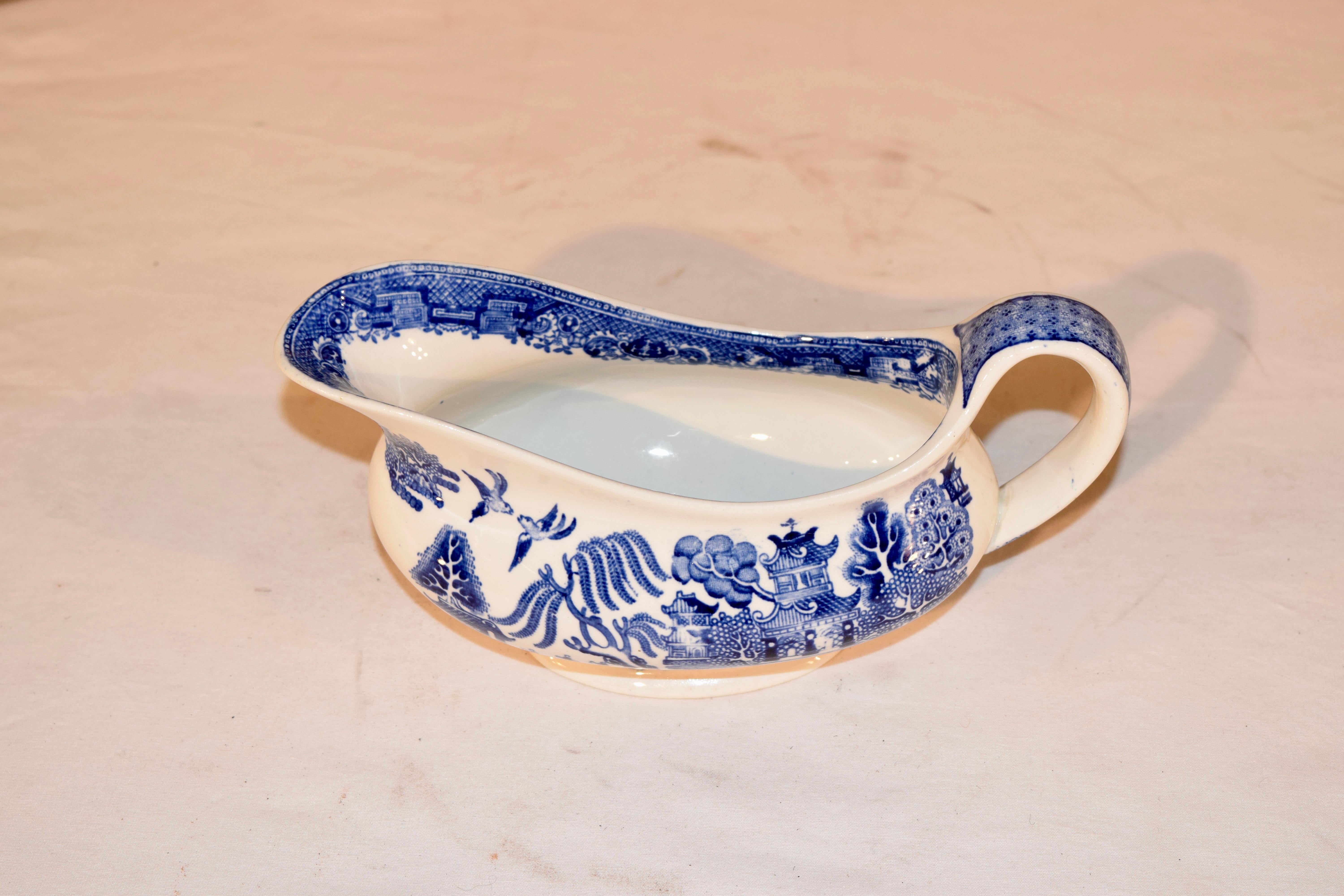 Late 19th century English pottery gravy boat in the famous blue willow pattern. Maker's mark is for William Adams and Sons, which were located in Tunstall.