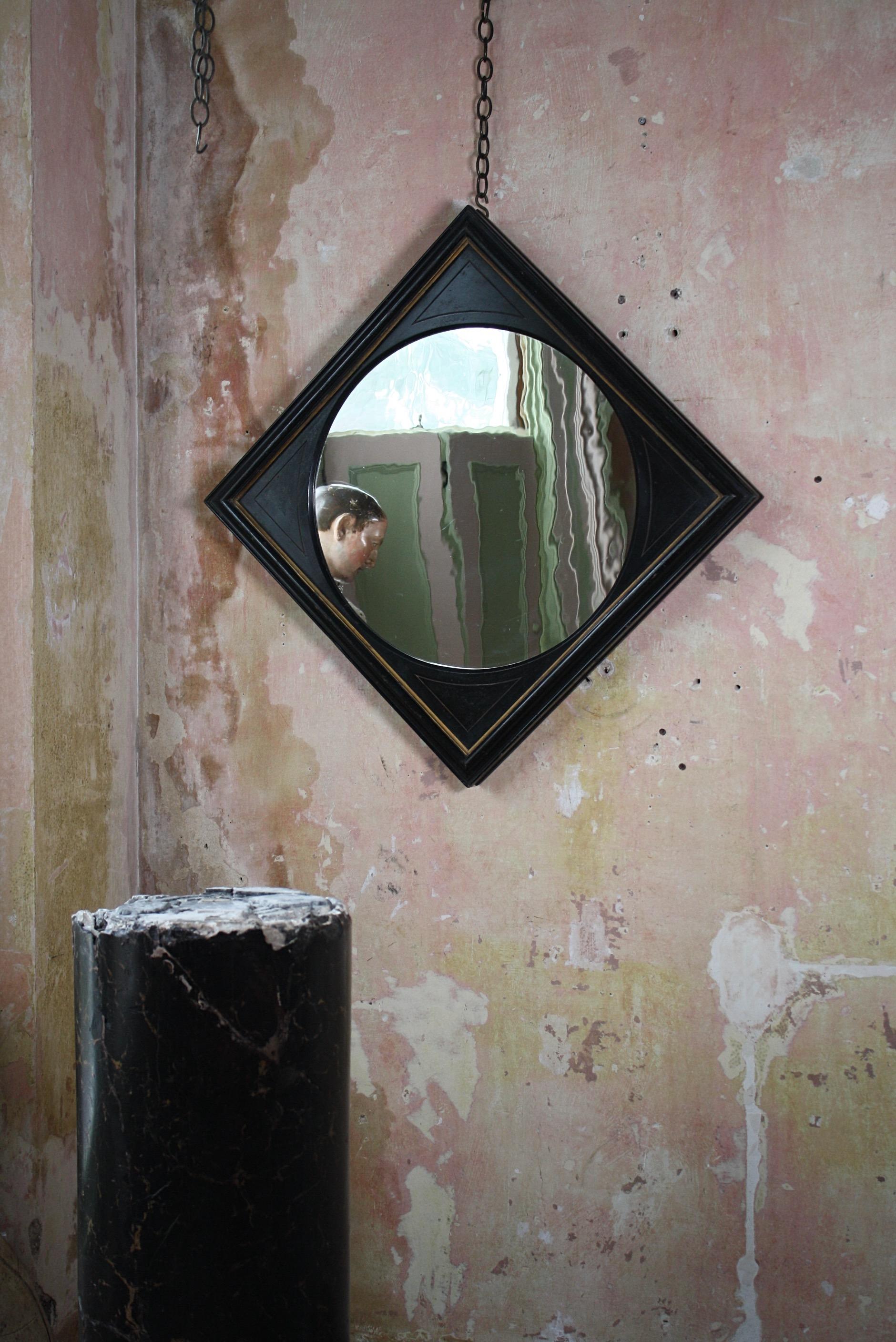 A totally untouched, reserved in style, aesthetic movement mirror. Pine in construction with its original ebonised finished and lineal gilt decoration.

The mirror plate has a wonderful ripple effect, giving a slightly distorted reflection on