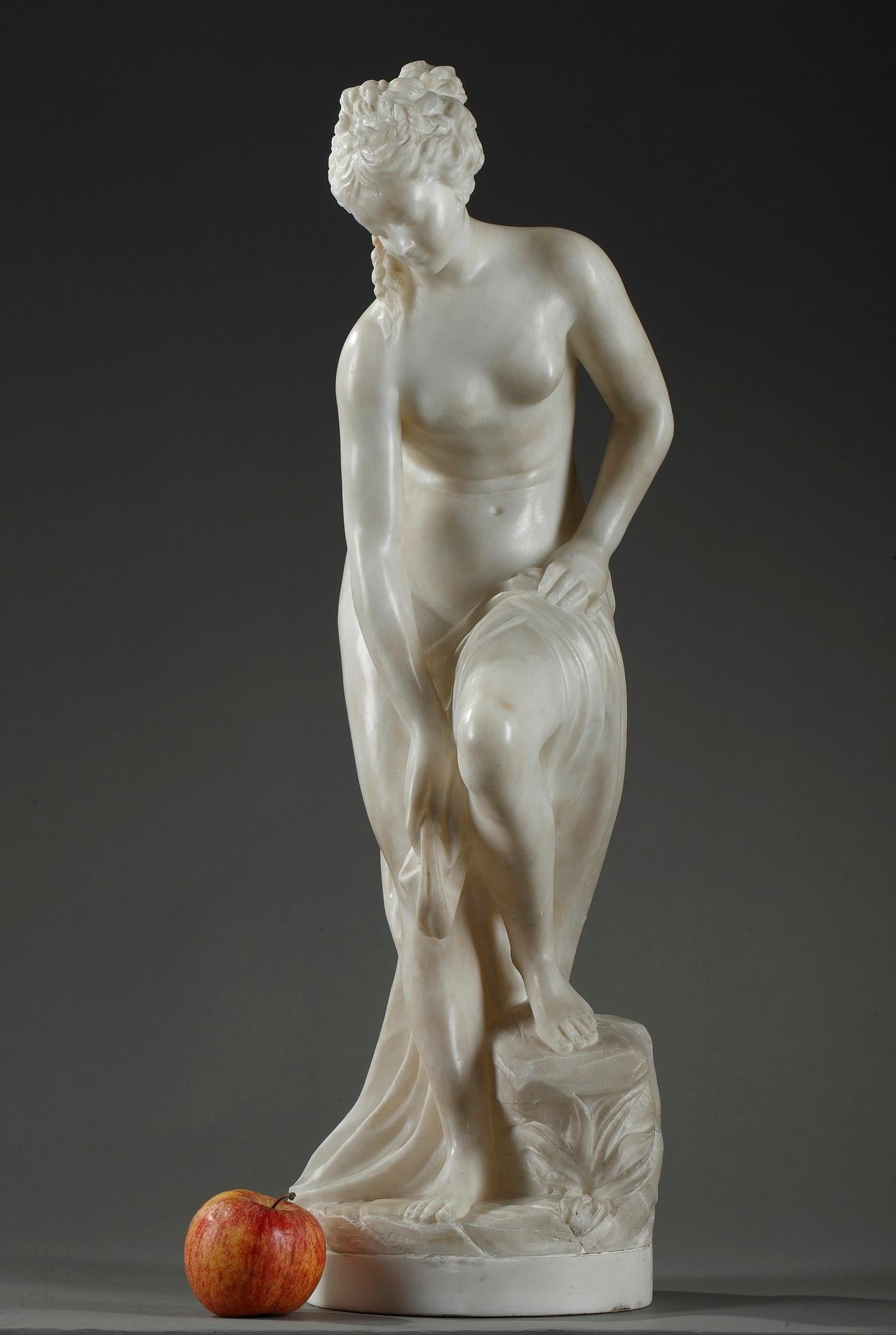 Alabaster statue featuring a nude bather removing the drape around her hips while advancing toward the river. Her light contraposto pose accentuates her feminine curves. Carved of alabaster, the sculpture exhibits neoclassical grace. This enchanting