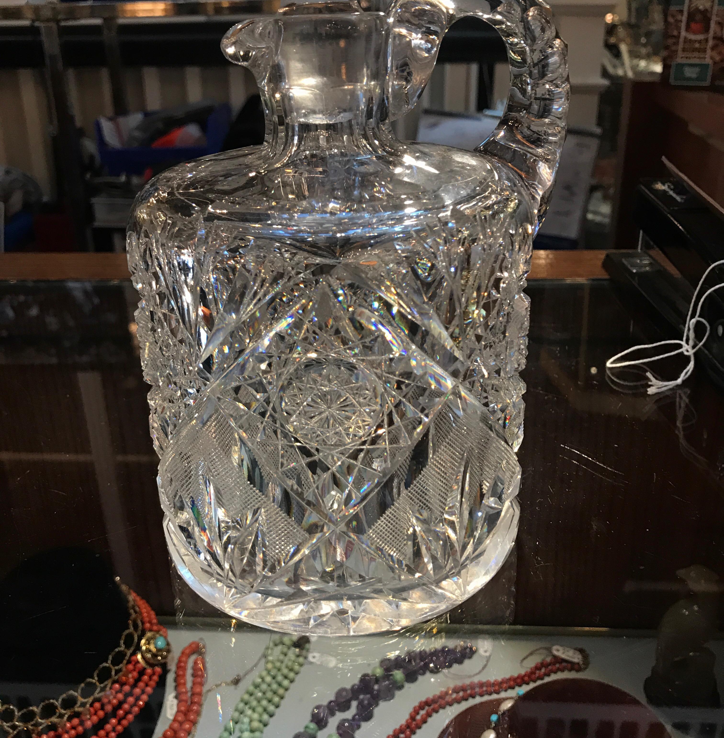 American Brilliant cut glass whiskey jug with original stopper. Hundreds of hand cuts with notched handle and faceted stopper.